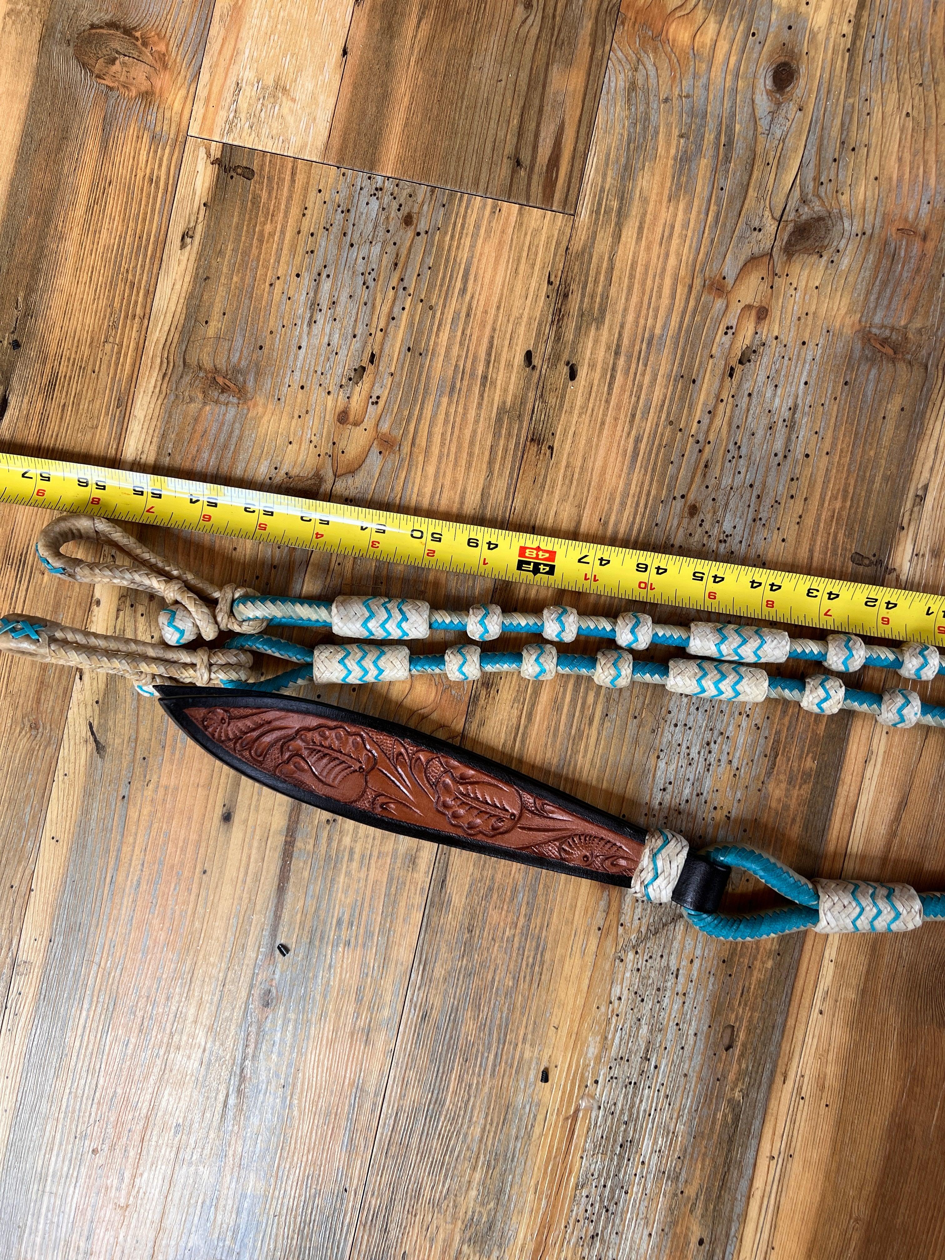 Brown leather horse halter with floral tooling and turquoise rope accents
