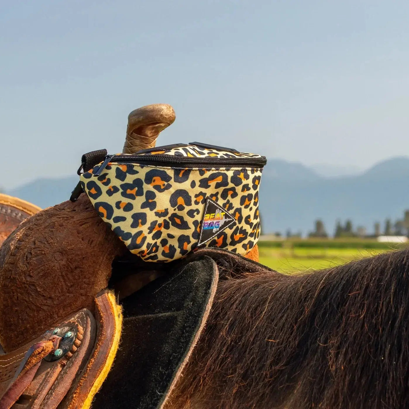 The BEAT BAG leopard-print saddlebag with black zipper and logo patch