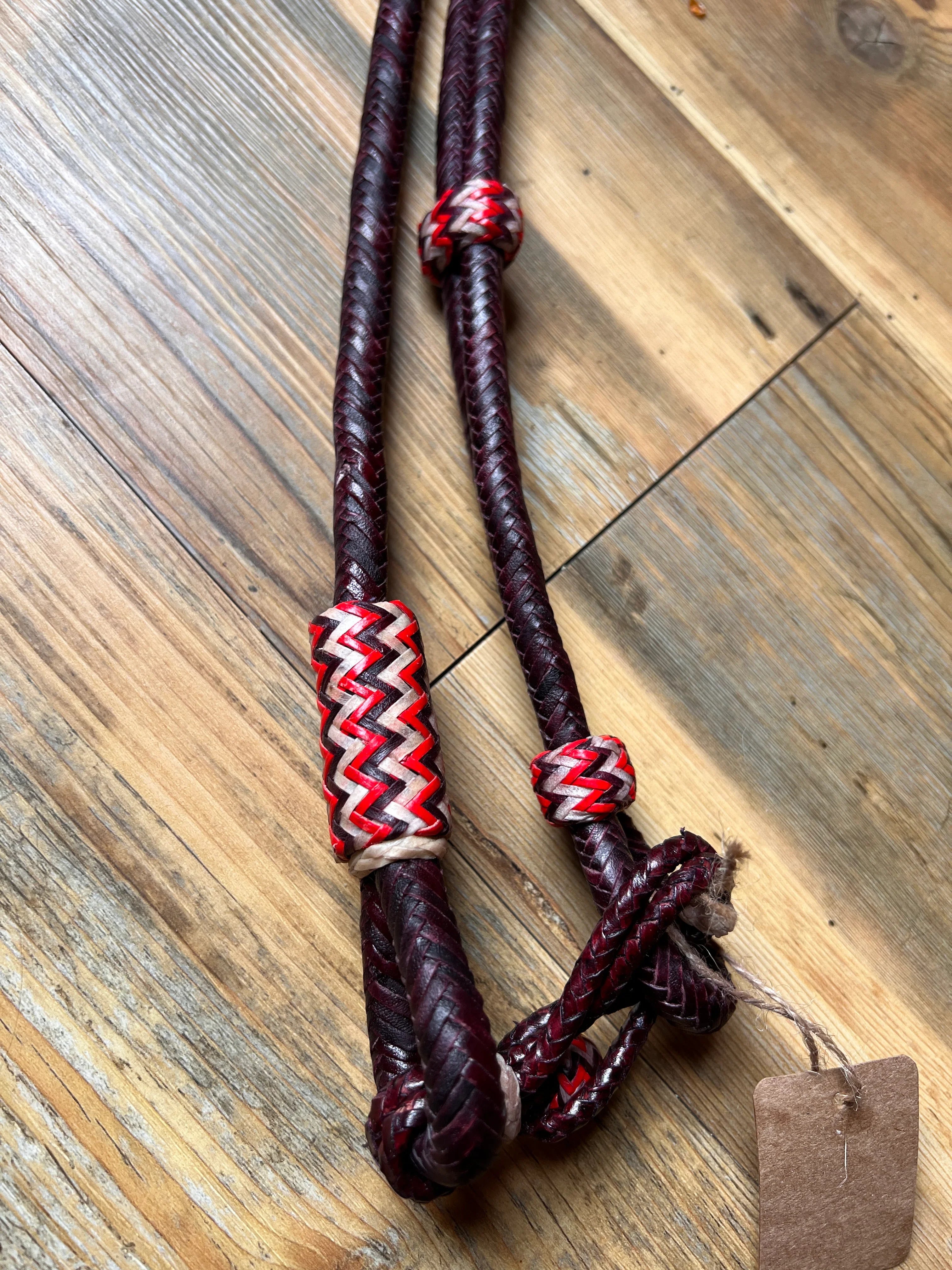 Dark cherry 20-plait romal reins with burgundy braided leather and zigzag beads