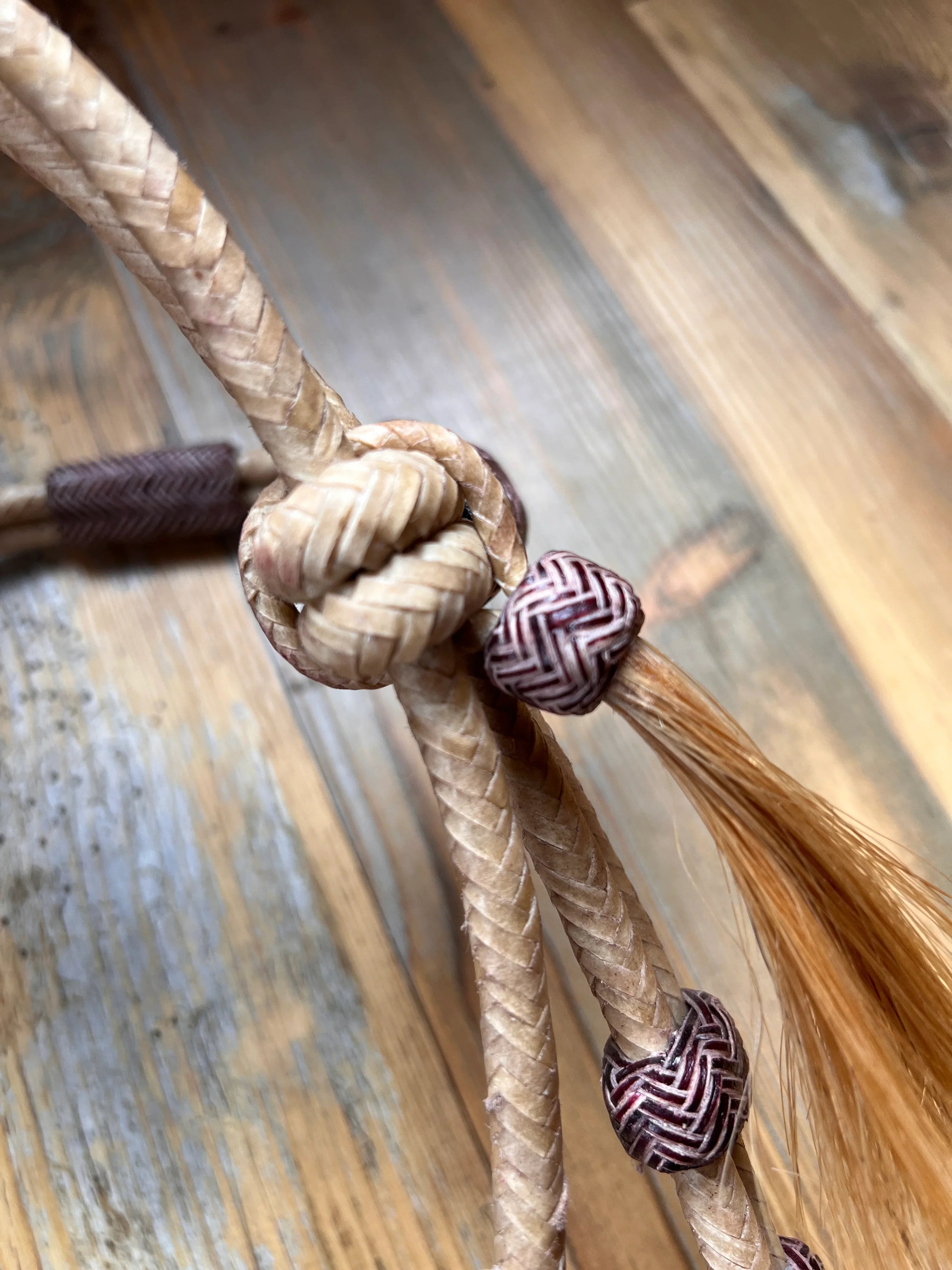 Rawhide Broadband Headstall with beige braided rope, purple beads and loose knot