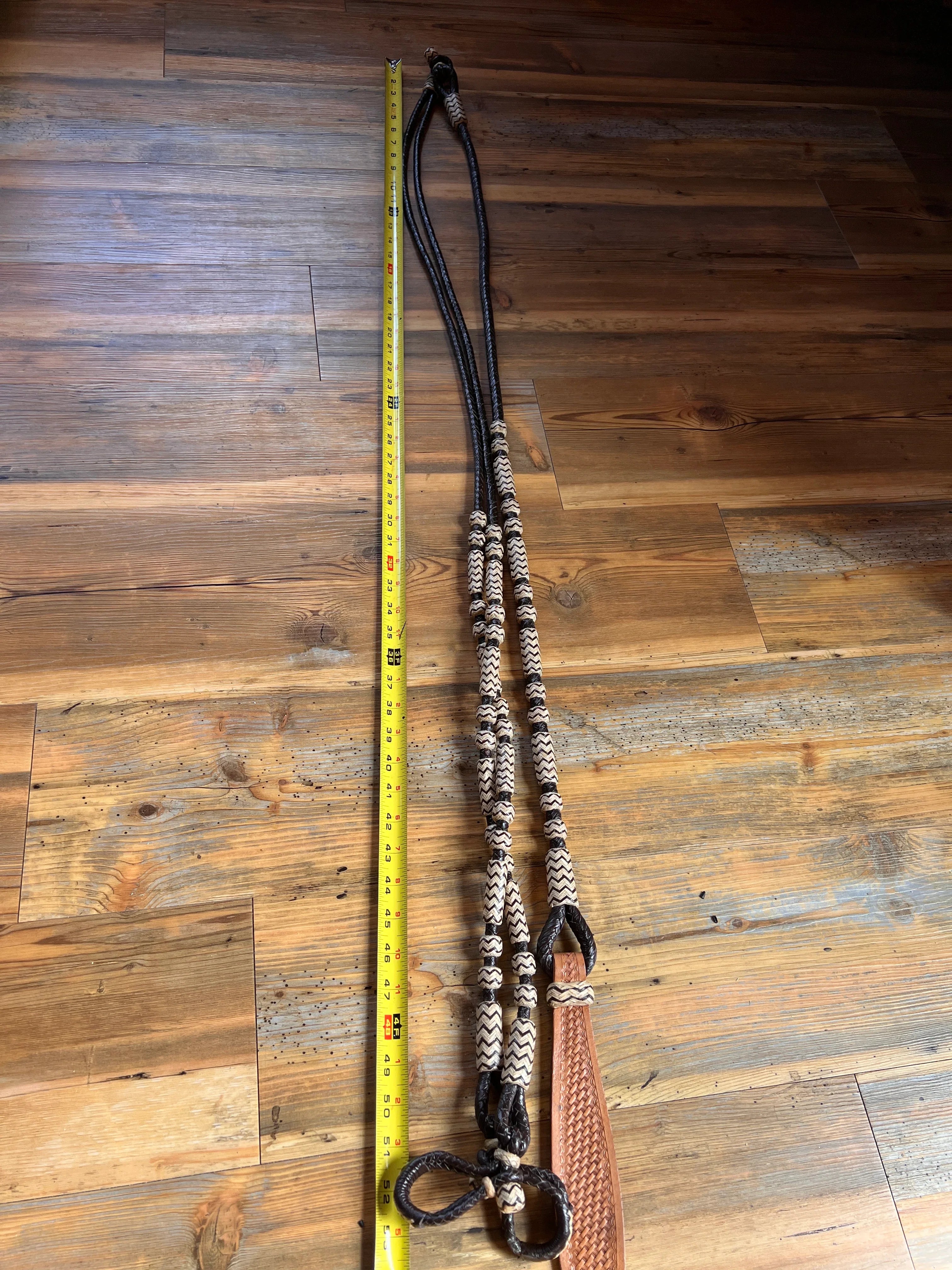 Black and tan braided leather horse halter with woven bead accents