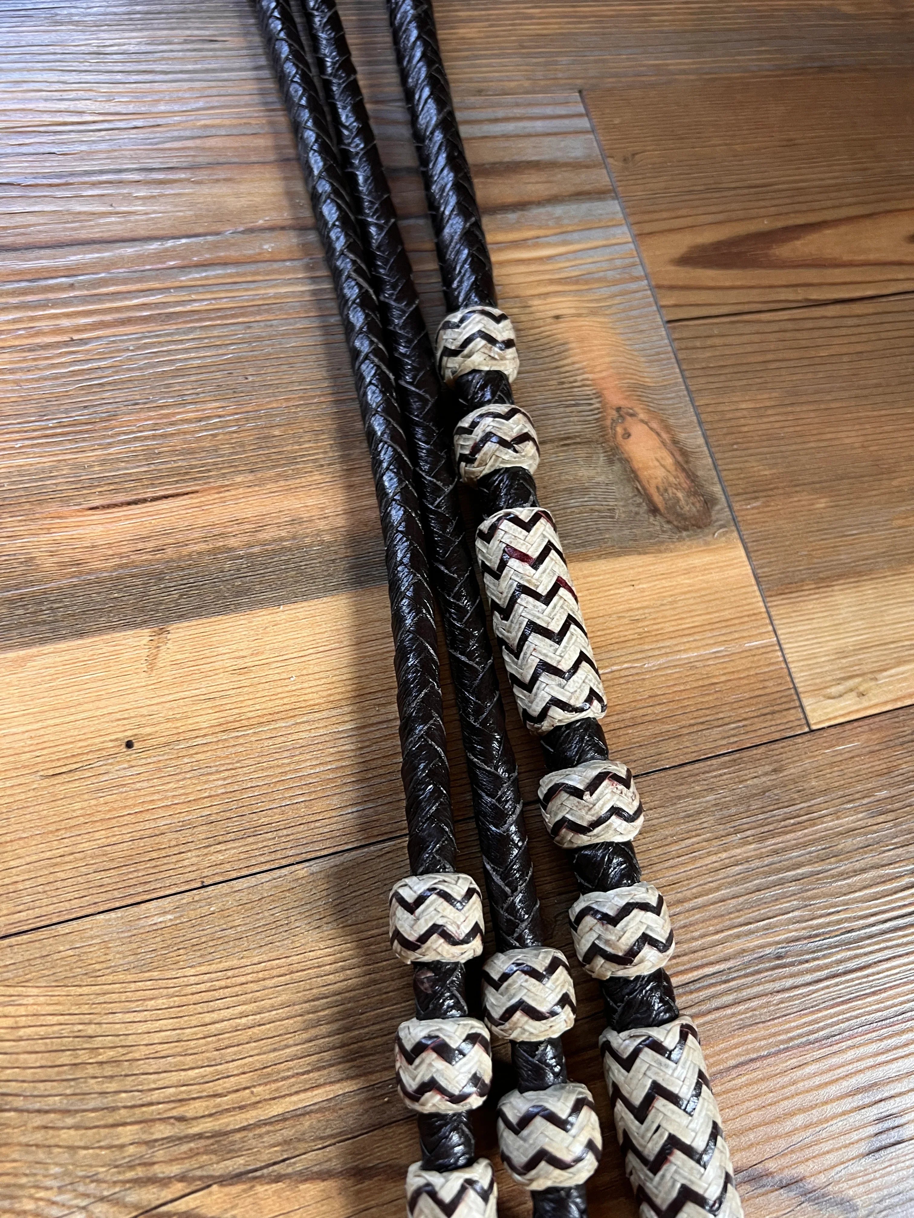 Black braided leather Romal reins with cream zigzag beads, 10 plaits, 55
