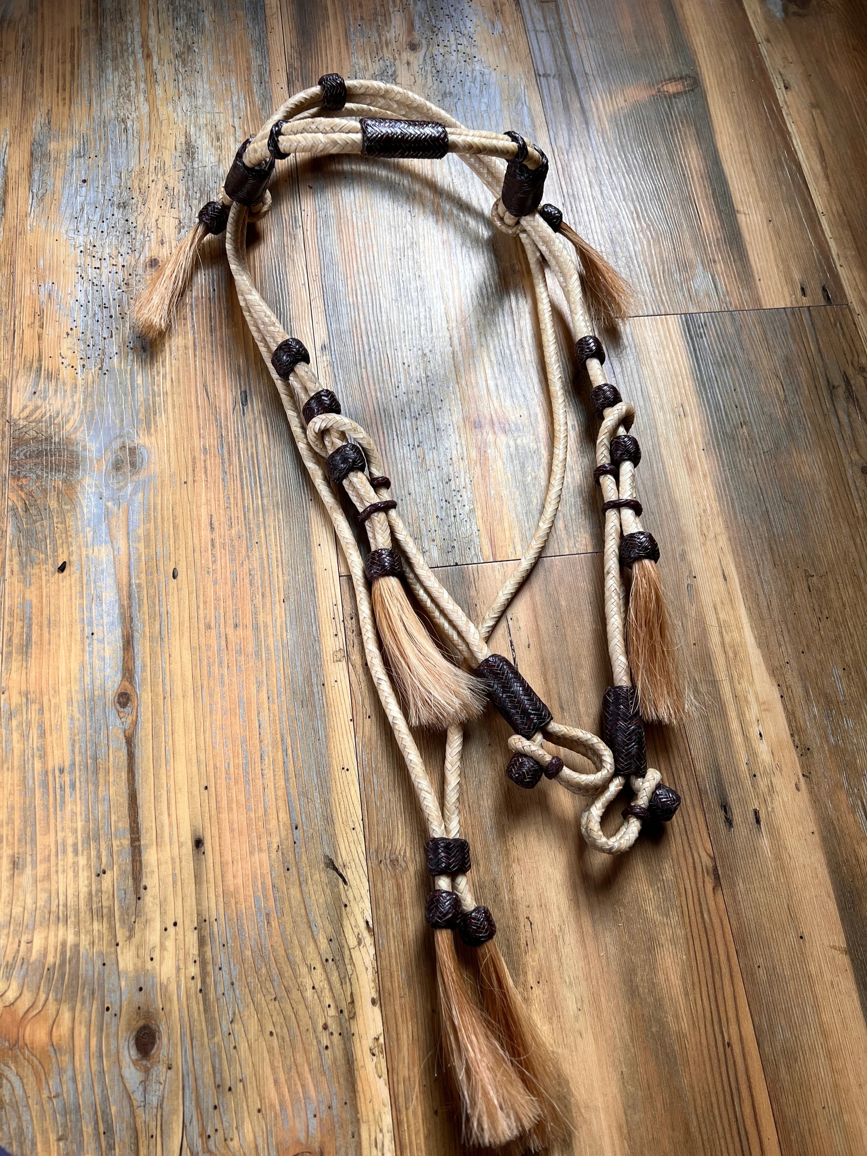 Beige black 16-plait rawhide horse headstall with mane tassels