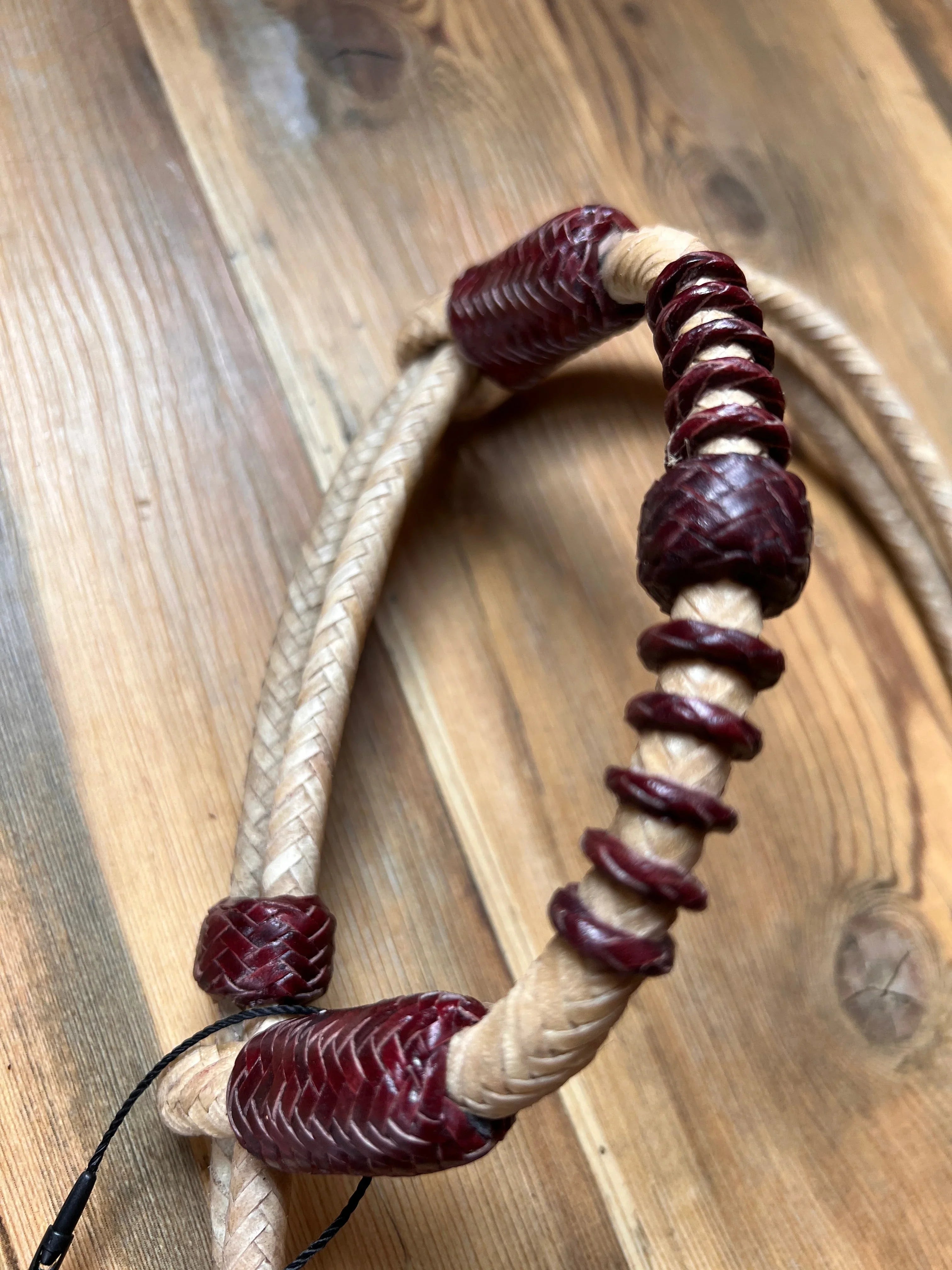 Hand-crafted braided leather one-ear Western horse headstall with tan and burgundy knots