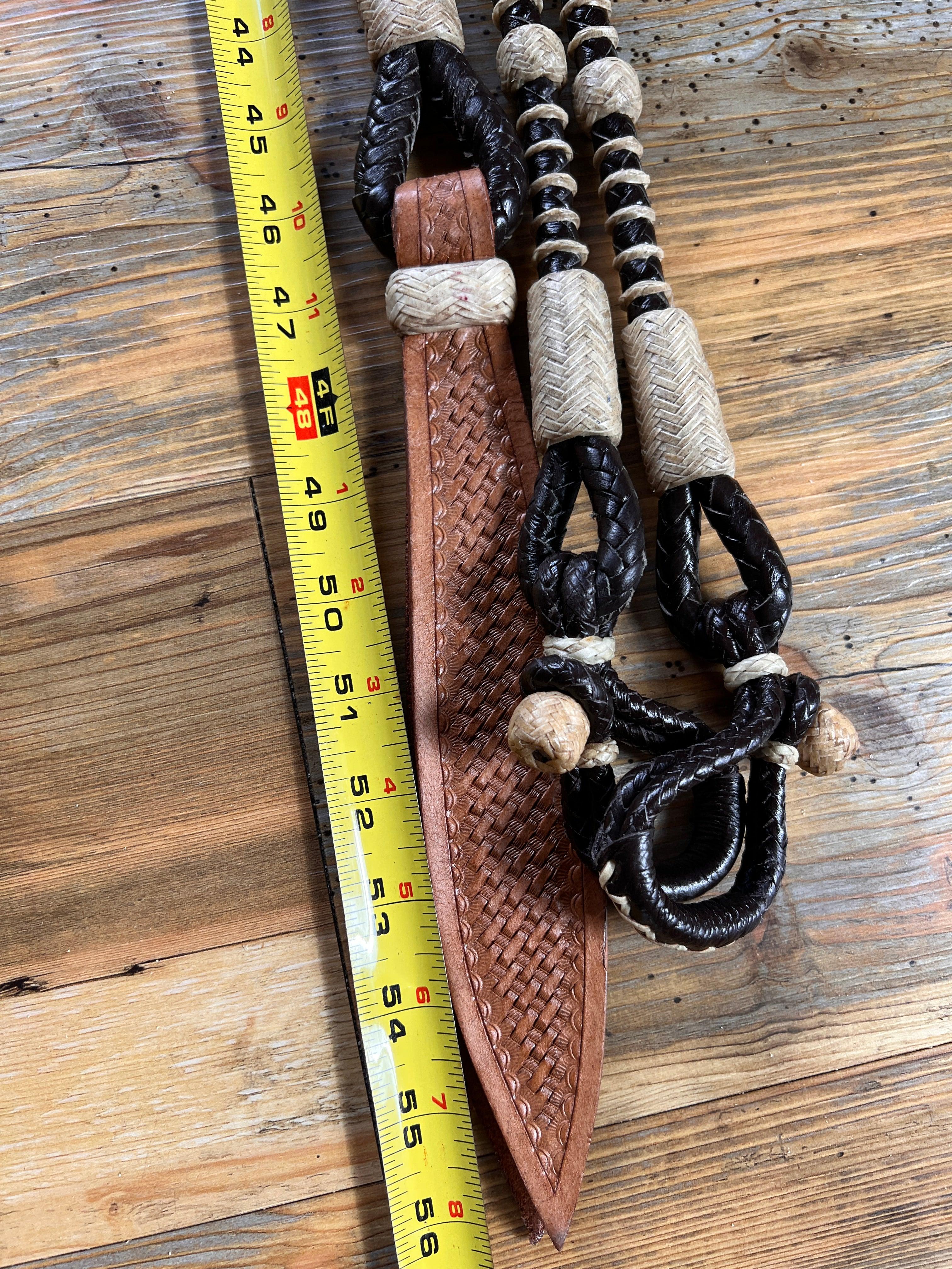 Brown leather knife sheath with woven texture on 10-plait romal reins