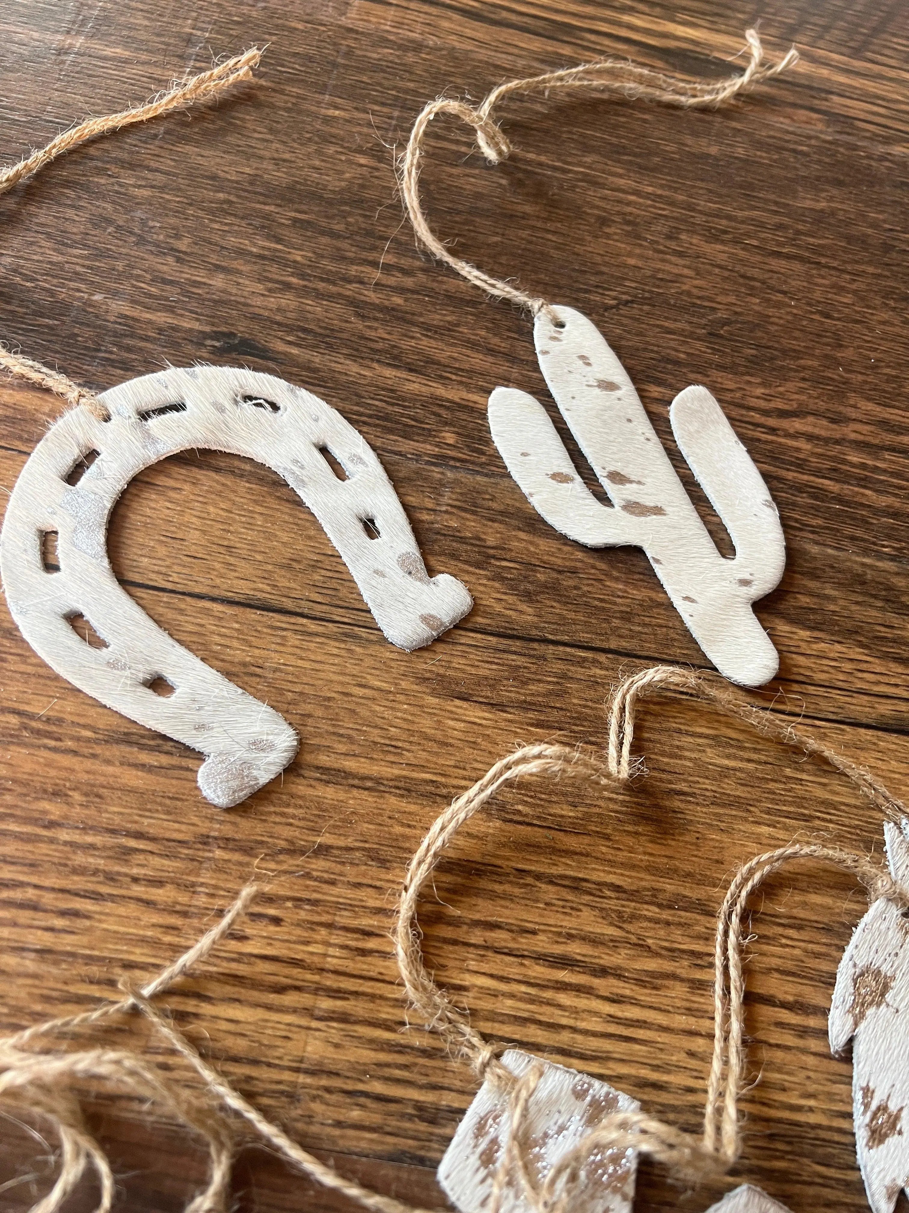 White cowhide Christmas ornaments in silver brown acid wash leather