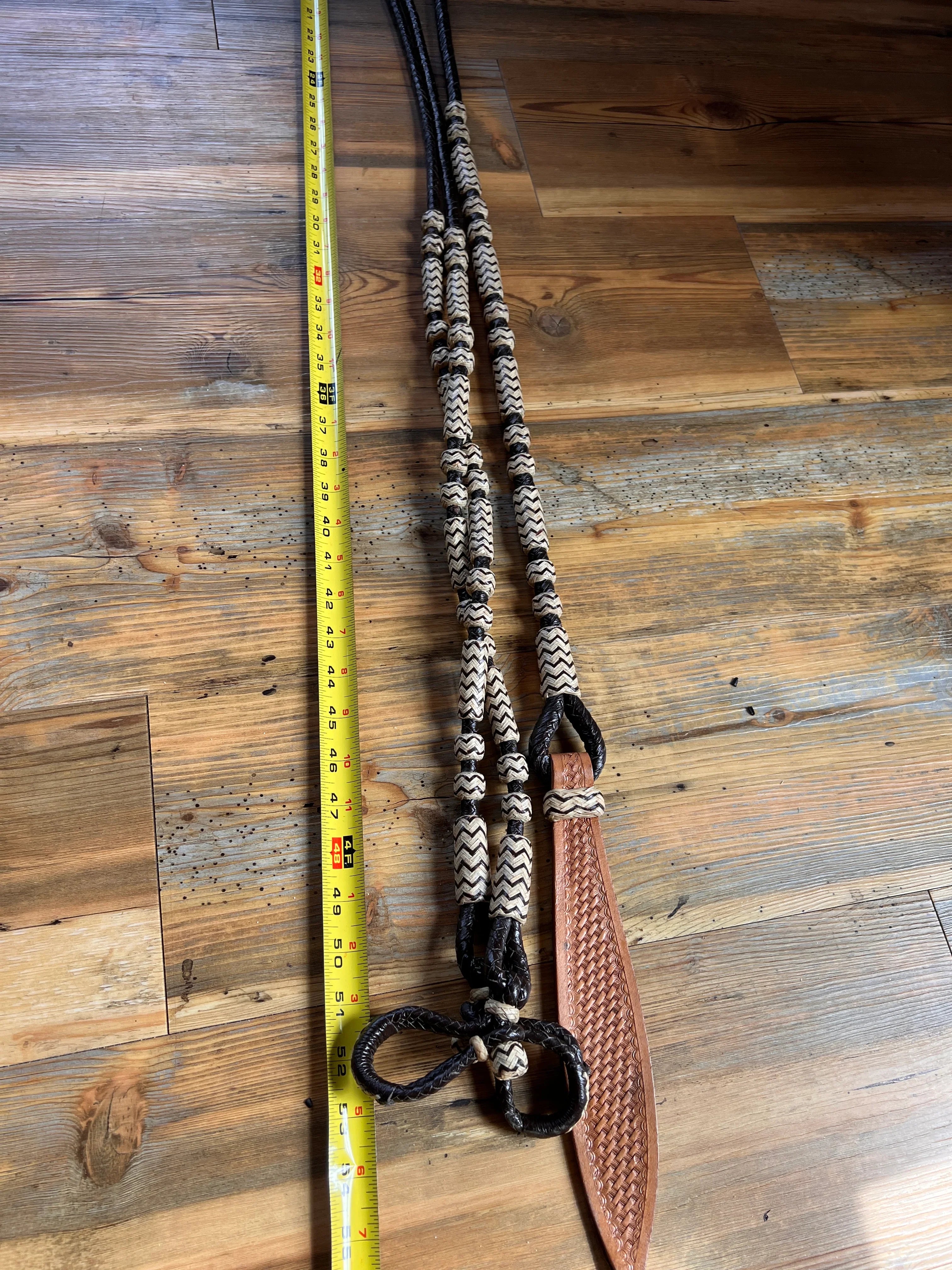 Black and cream chevron 10-plait romal reins with tan woven bit, 55 inches