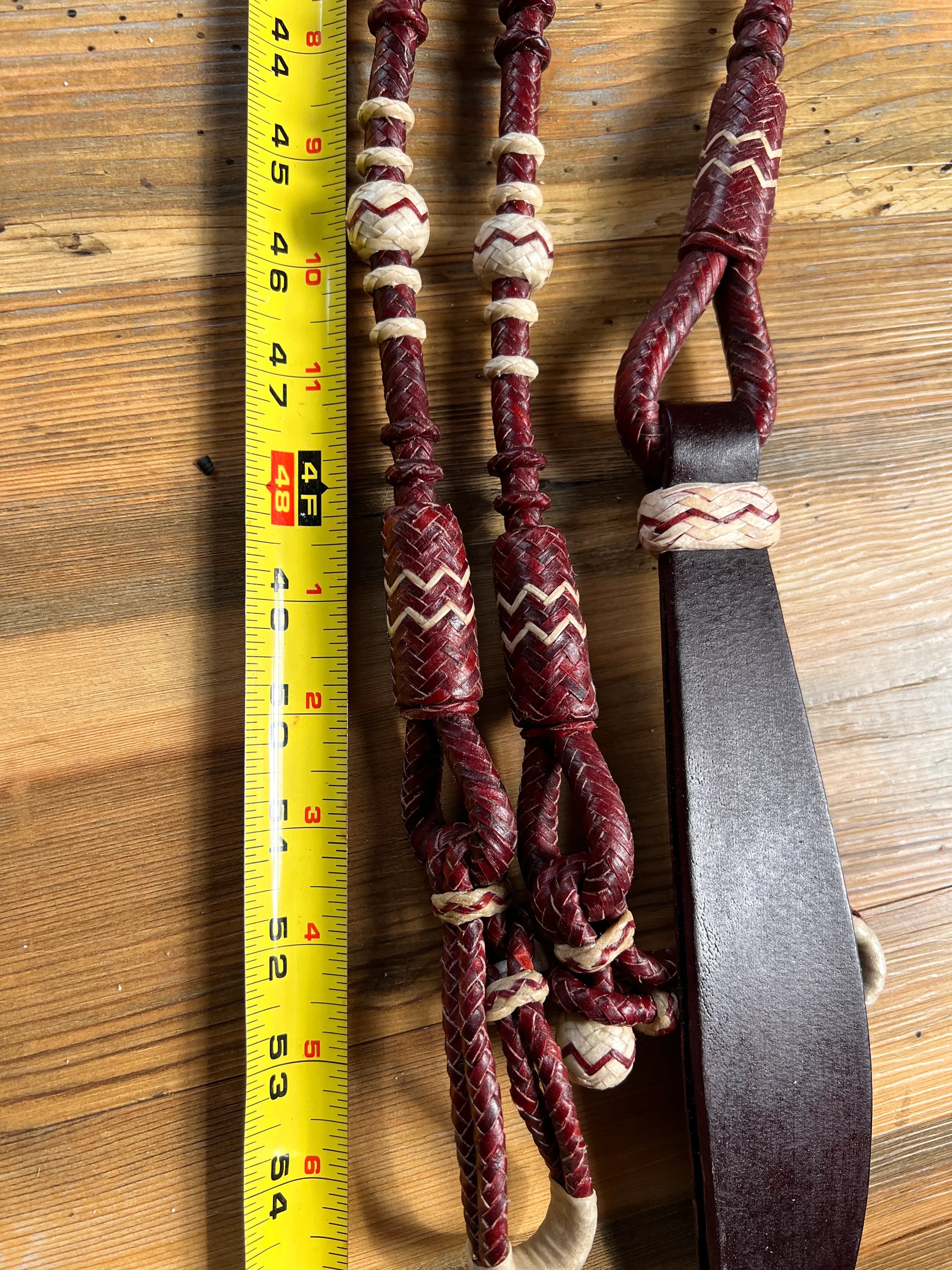 Maroon and cream 20-plait braided romal reins with zigzag patterns