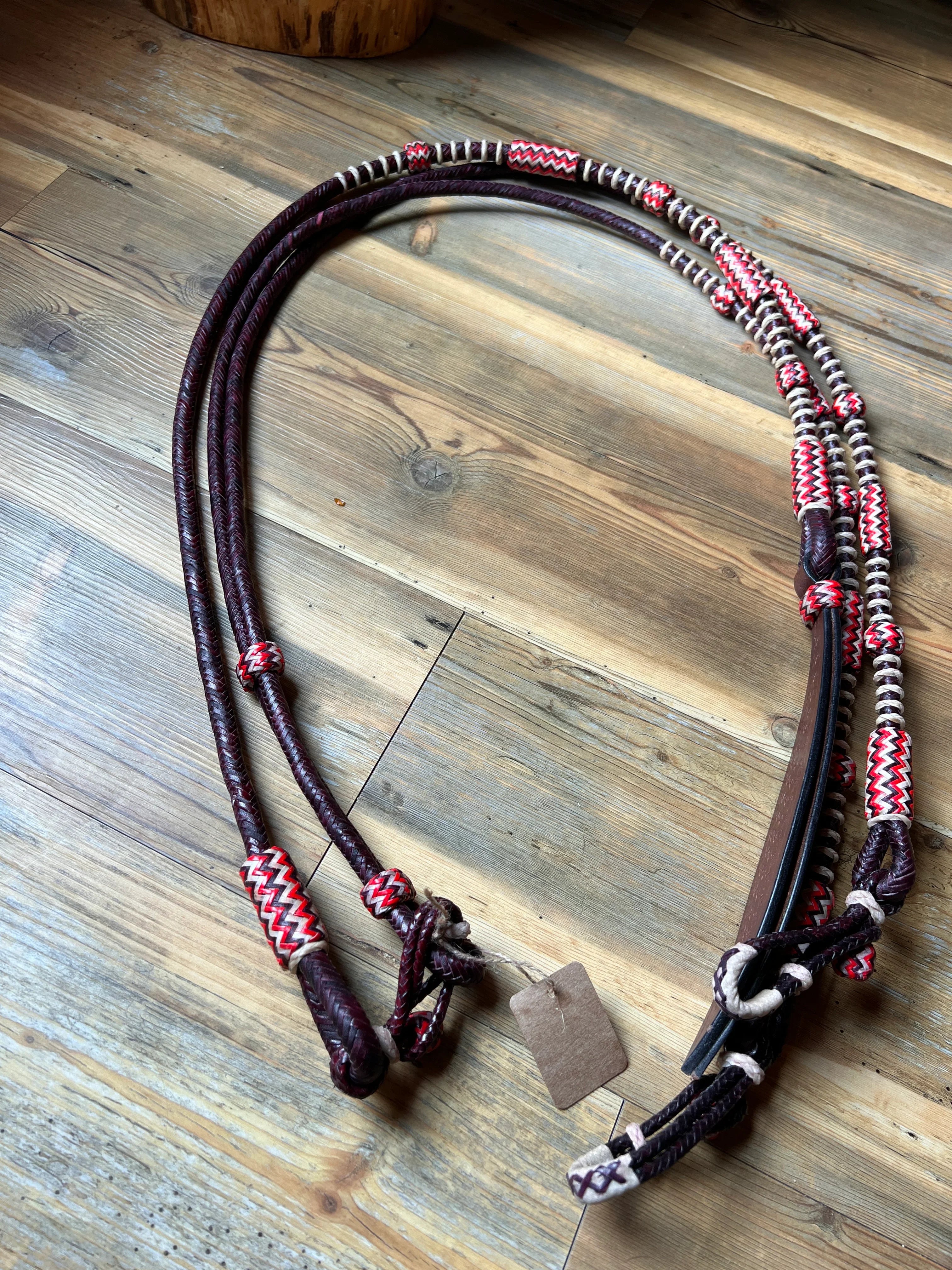Maroon and white braided leather horse halter with zigzag patterns, California style
