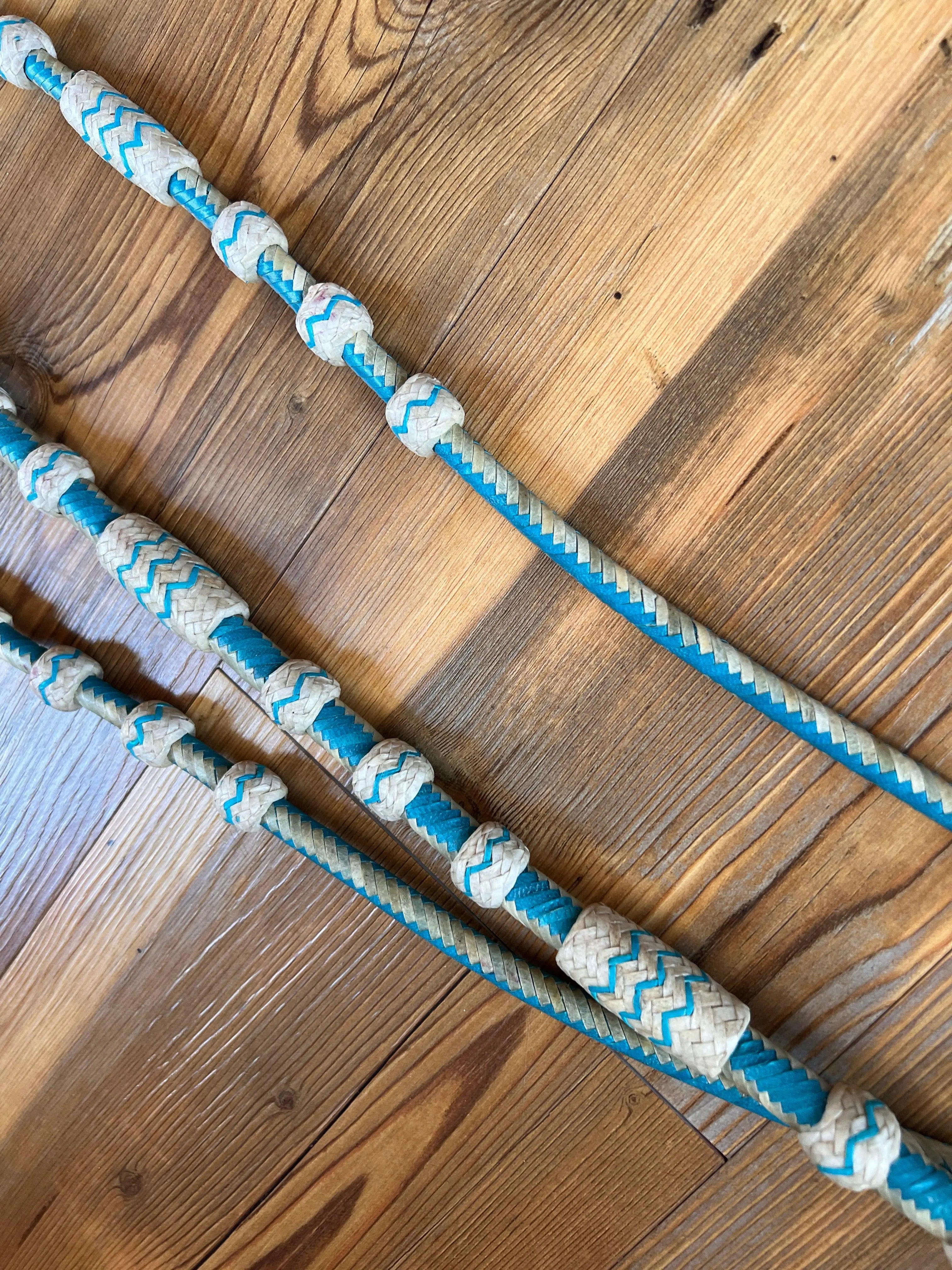 Romal Reins Natural and Turquoise Rawhide 20 Plaits Romal Reins close up
