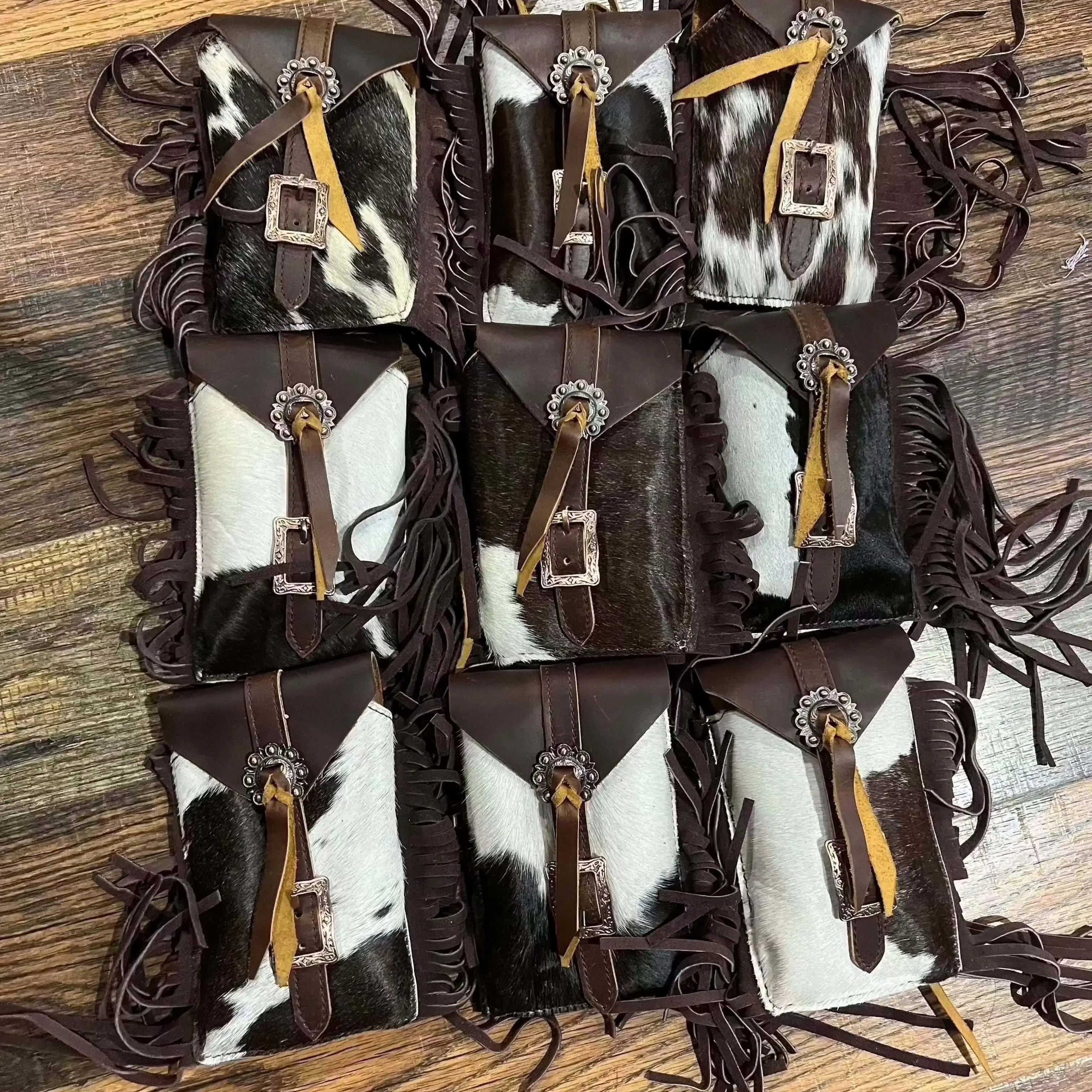 Rear view of Hair on Cowhide Saddle Bag Rear Cinch with brown white fringed pouches silver buckles