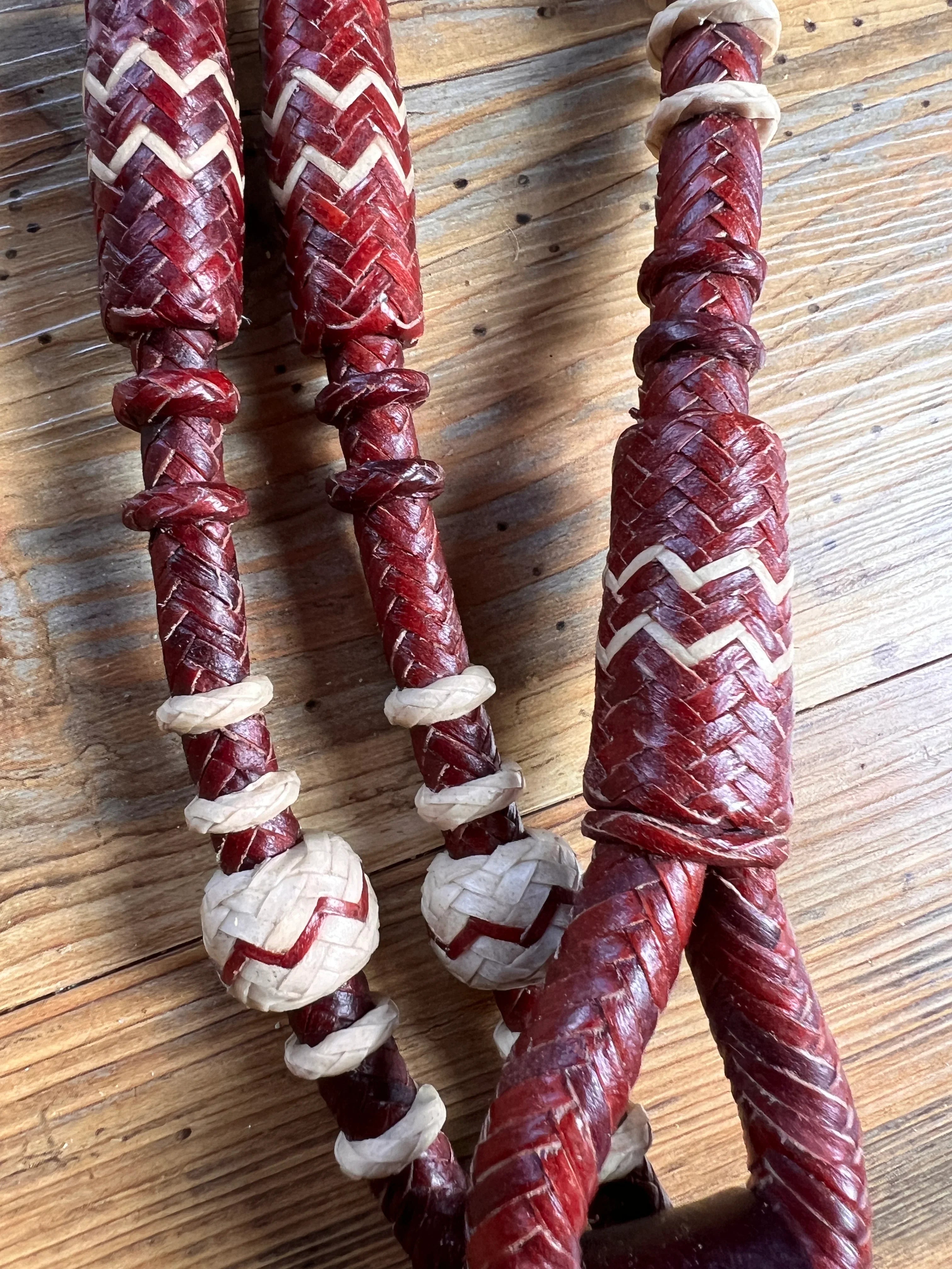 Red and cream 20-plait braided romal reins with zigzag accents