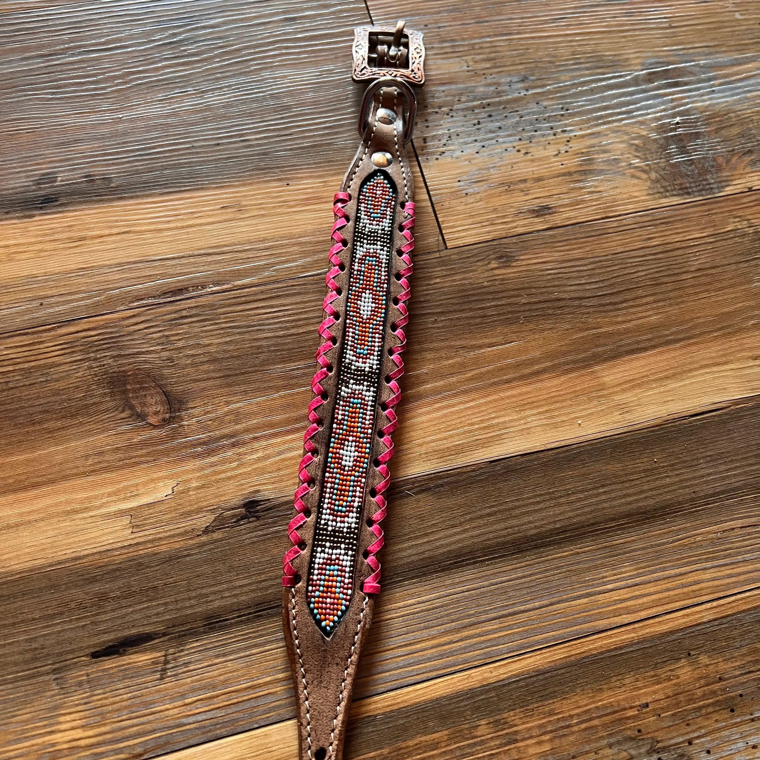 Genuine leather dog collar with pink, white, and gold southwest beaded inlay design, a rawhide wrapped edge Dog