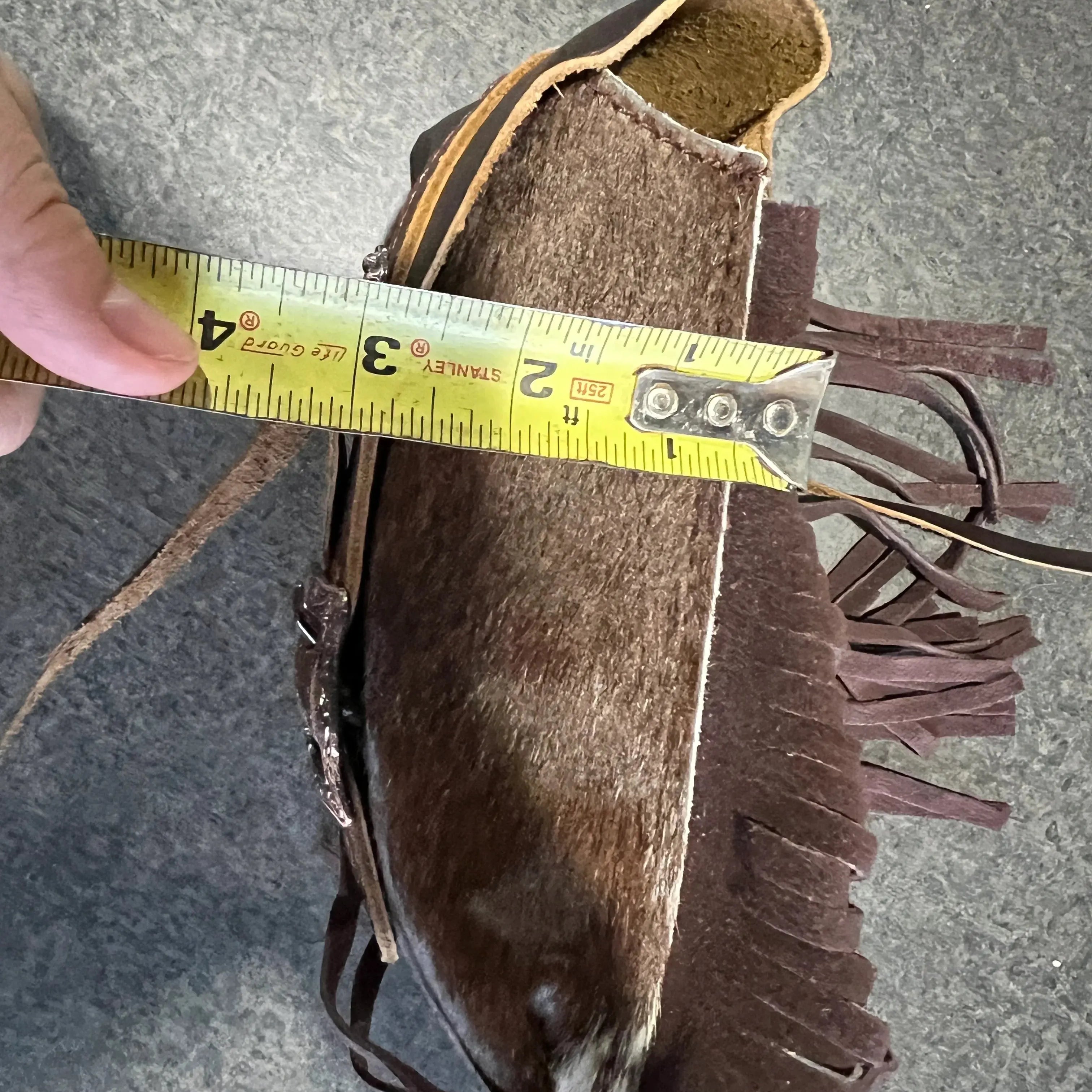 Brown leather fringed moccasin with lining on Hair on Cowhide Saddle Bag rear cinch