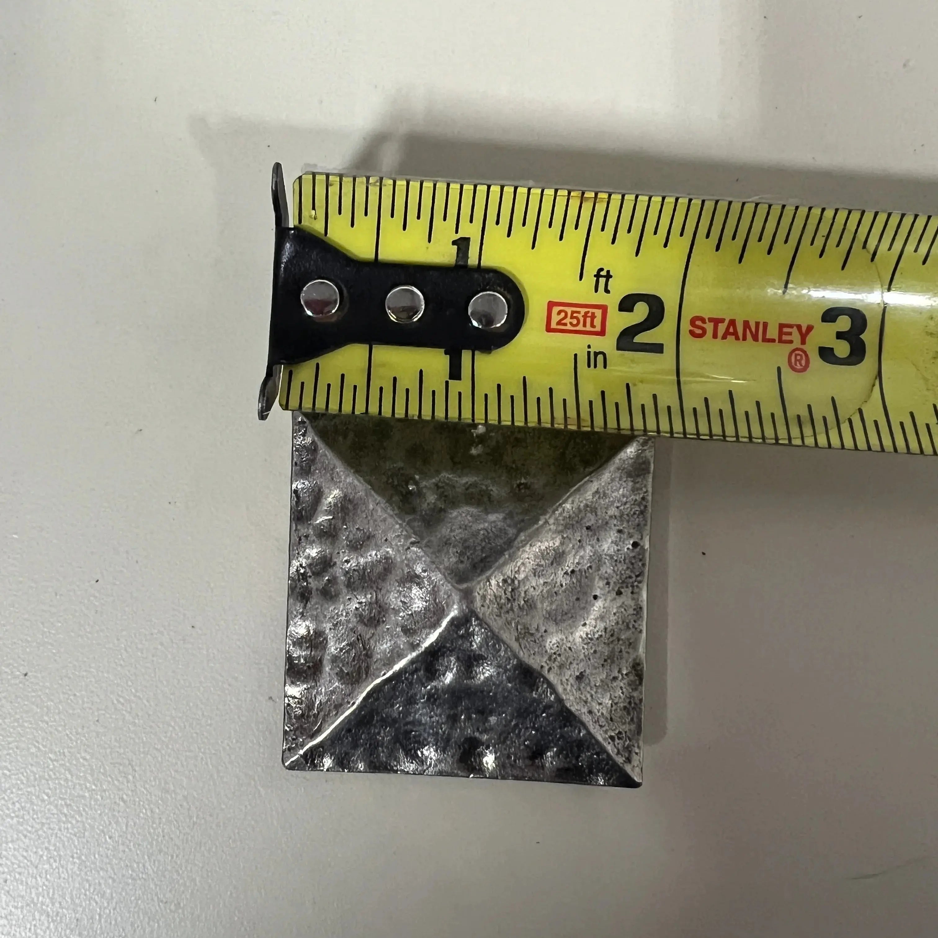 Silver pyramid shape concho with Screw.