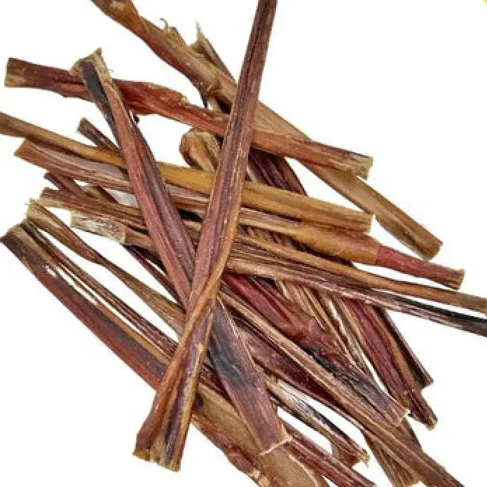 Pig pizzle stick: pile of dried twisted beef marrow in brown shades