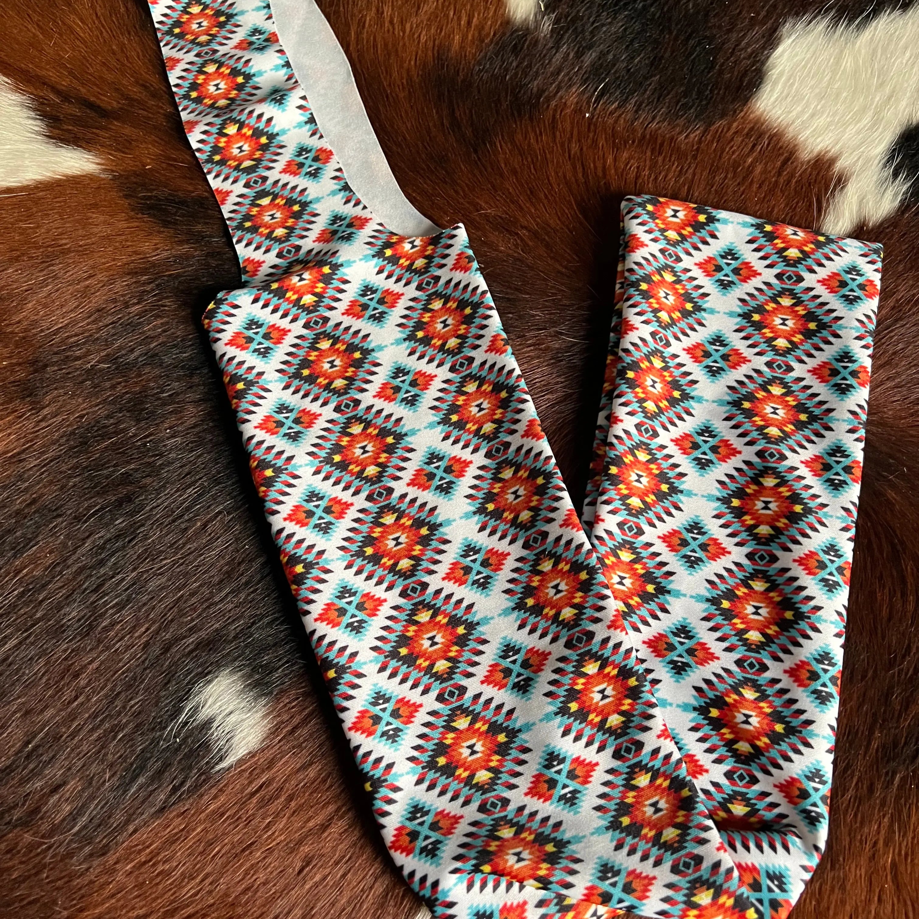 Orange & Teal Aztec Lycra printed slip on tail bag