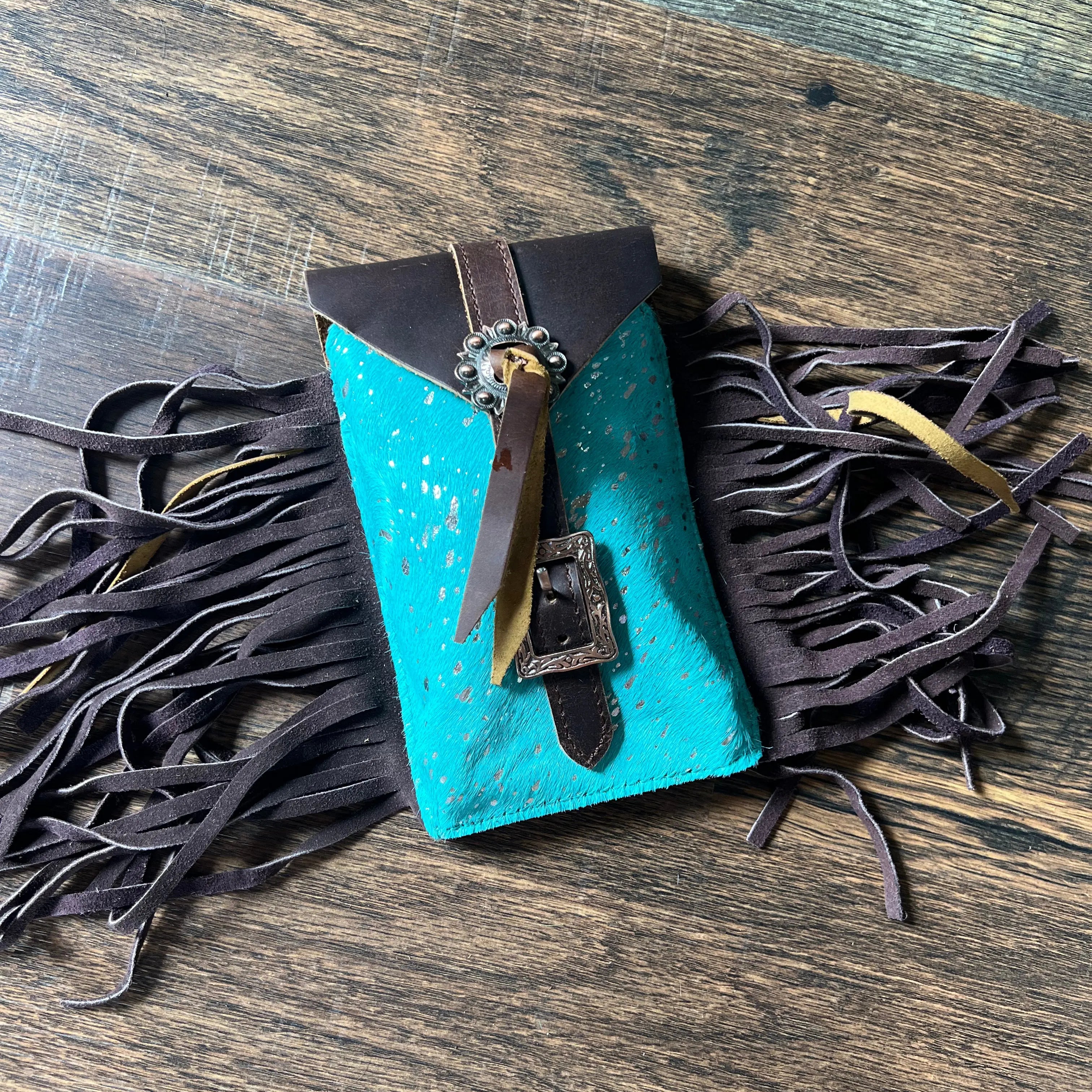 Back of Acid Wash Teal turquoise brown leather fringed phone case with silver buckle