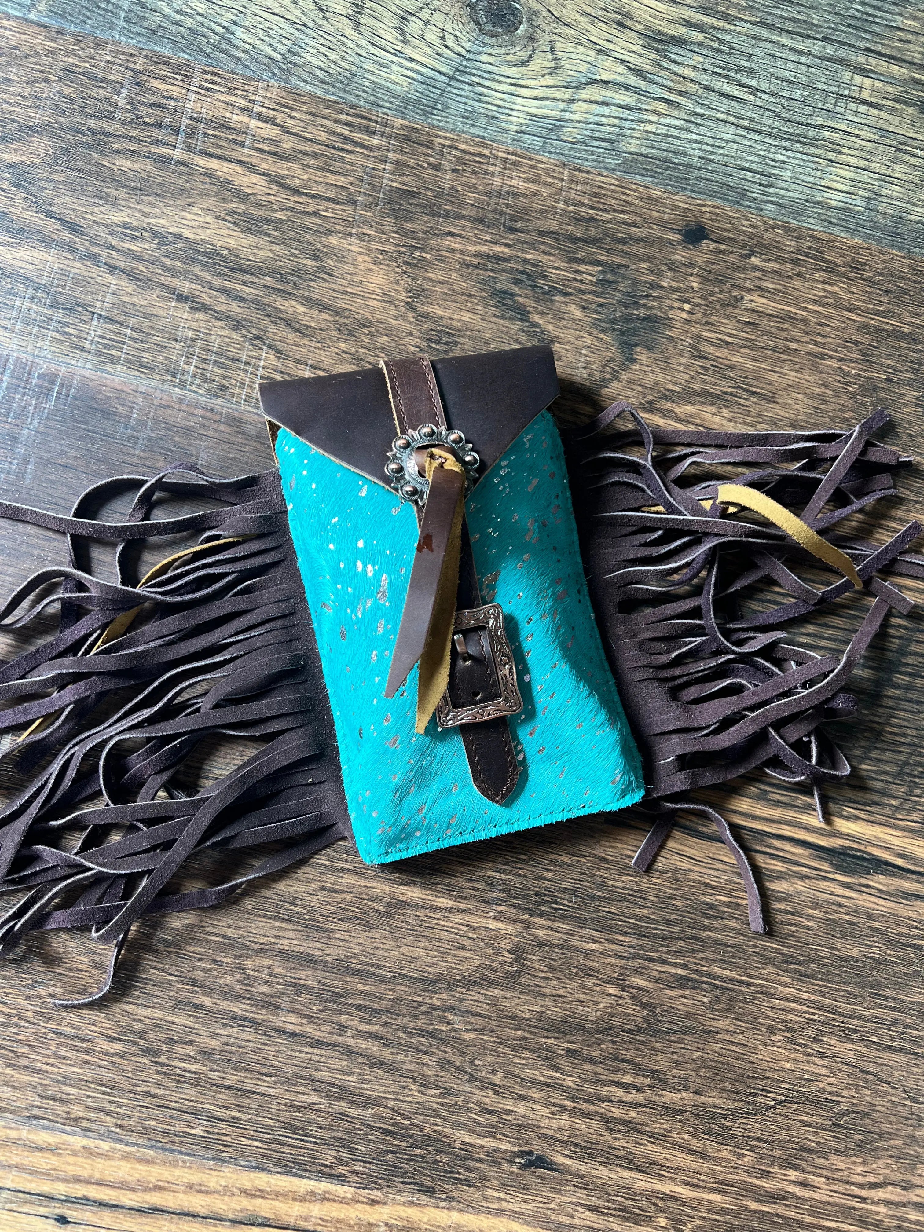 Back of Acid Wash Teal turquoise brown leather fringed phone case with silver buckle