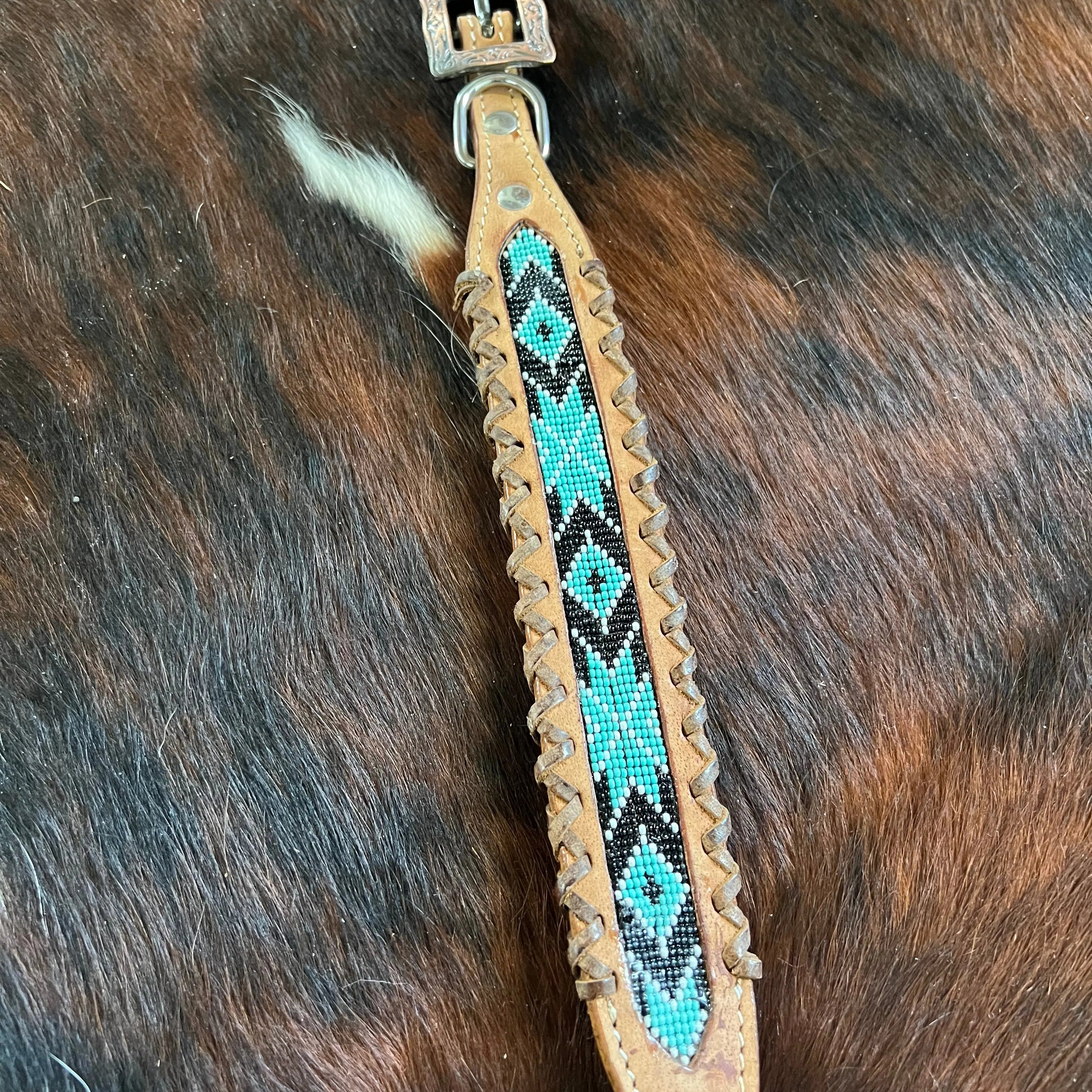 Genuine leather dog collar with teal, white, and black southwest beaded inlay design, a leather wrapped edge Dog