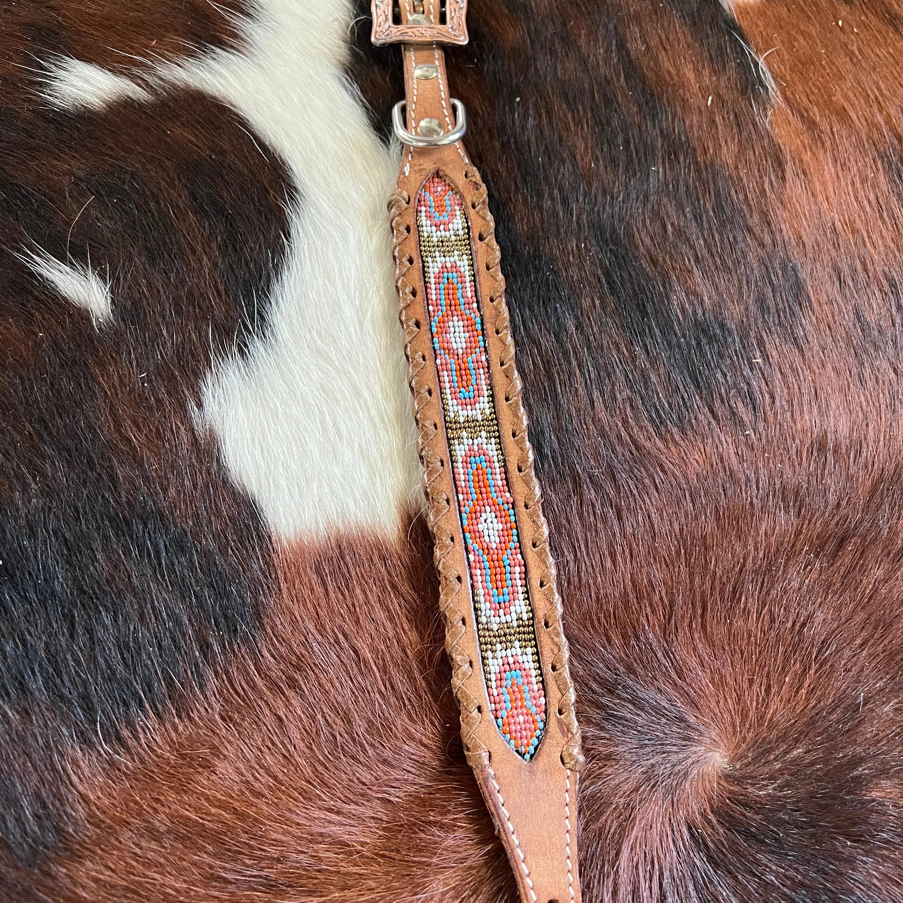 Genuine Leather dog collar with pink, white, and gold southwest beaded inlay design, a leather wrapped edge Dog