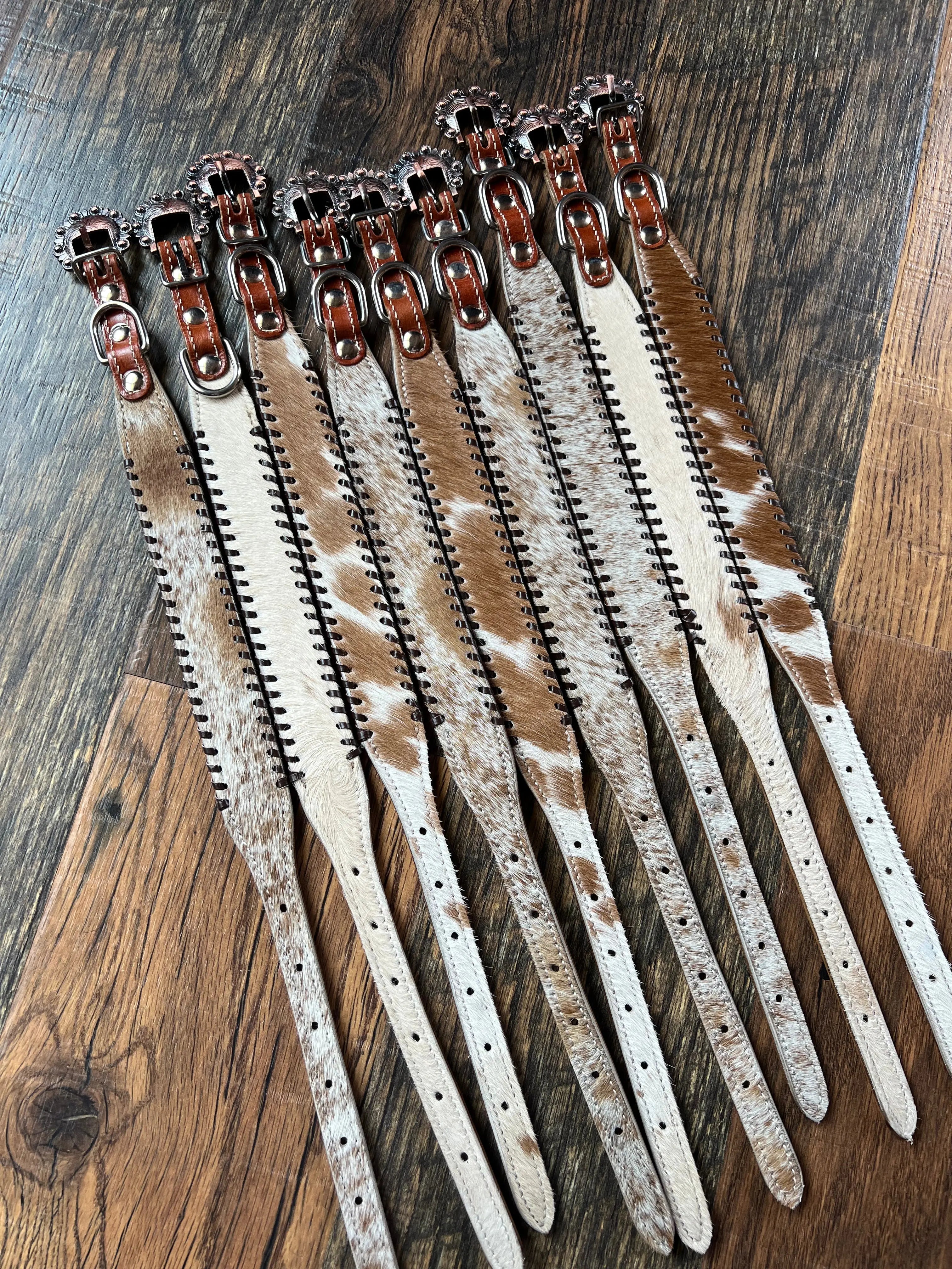 Brown and white cowhide leather dog collar with silver buckles and rawhide lacing