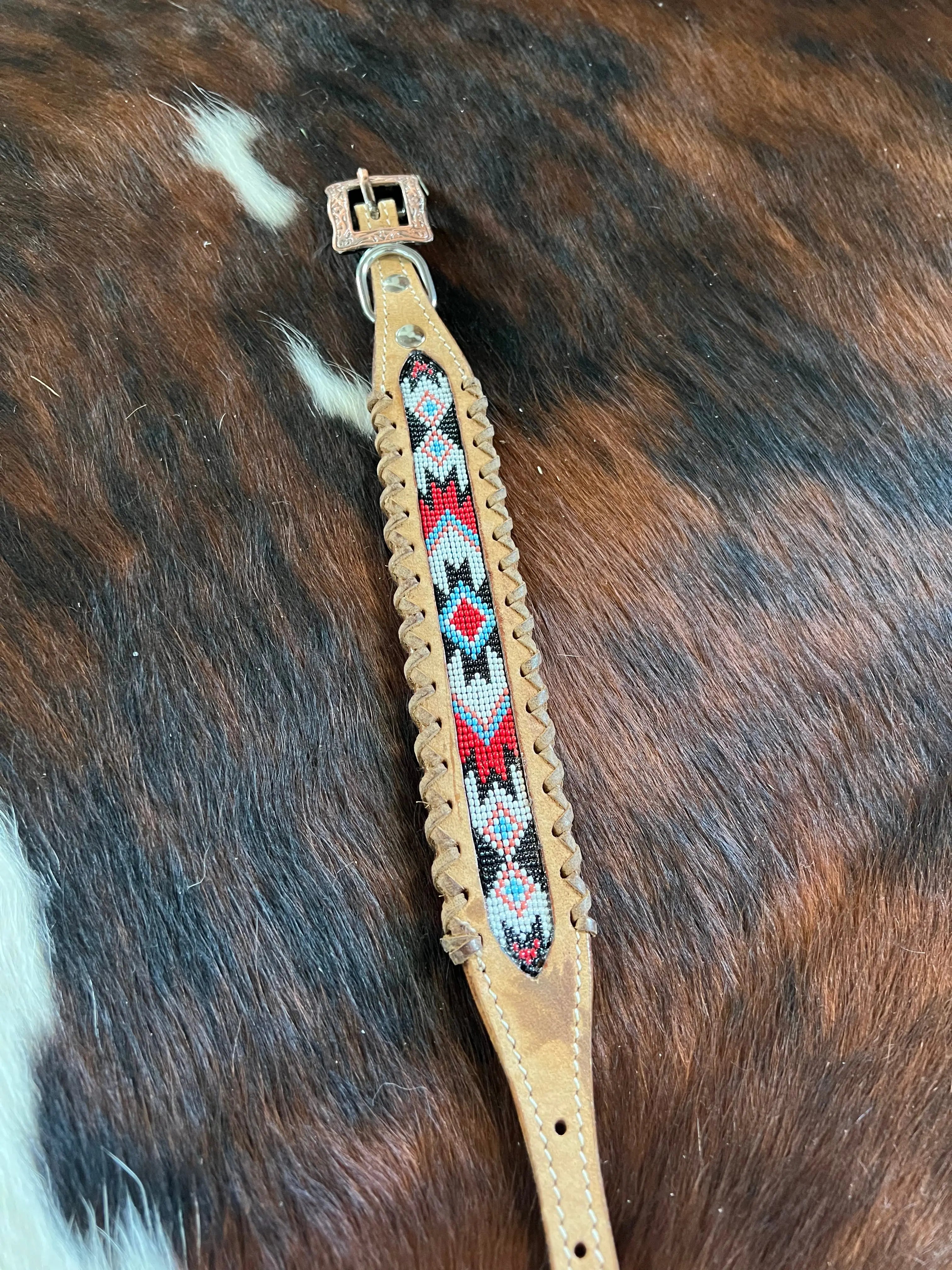 Genuine leather dog collar with red, white, and black southwest beaded inlay design, a leather wrapped edge Dog