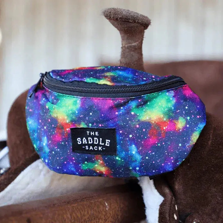 The Saddle Sack: vibrant galaxy-patterned fabric saddle sack with black zipper and branded patch