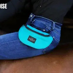 Turquoise Saddle Sack fanny pack with black zipper and brand patch
