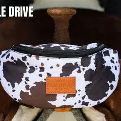 The Saddle Sack cowprint fanny pack with brown leather patch
