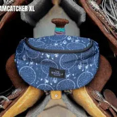 Blue patterned Saddle Sack with white circular designs and brown strap