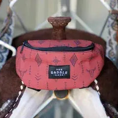Pink patterned The Saddle Sack fanny pack with black zipper and diamond motifs