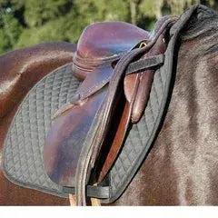 New Benefab therapeutic black saddle pad on brown leather saddle on horse