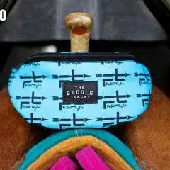 Turquoise Saddle Sack bag with repeating black ft logo pattern and The Saddle Shop label
