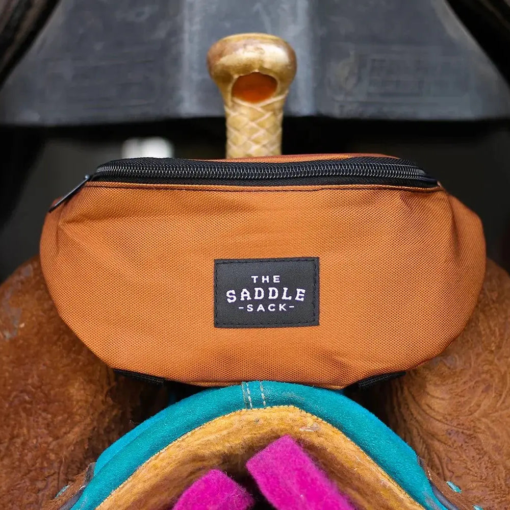 Orange fabric Saddle Sack with black zipper and label