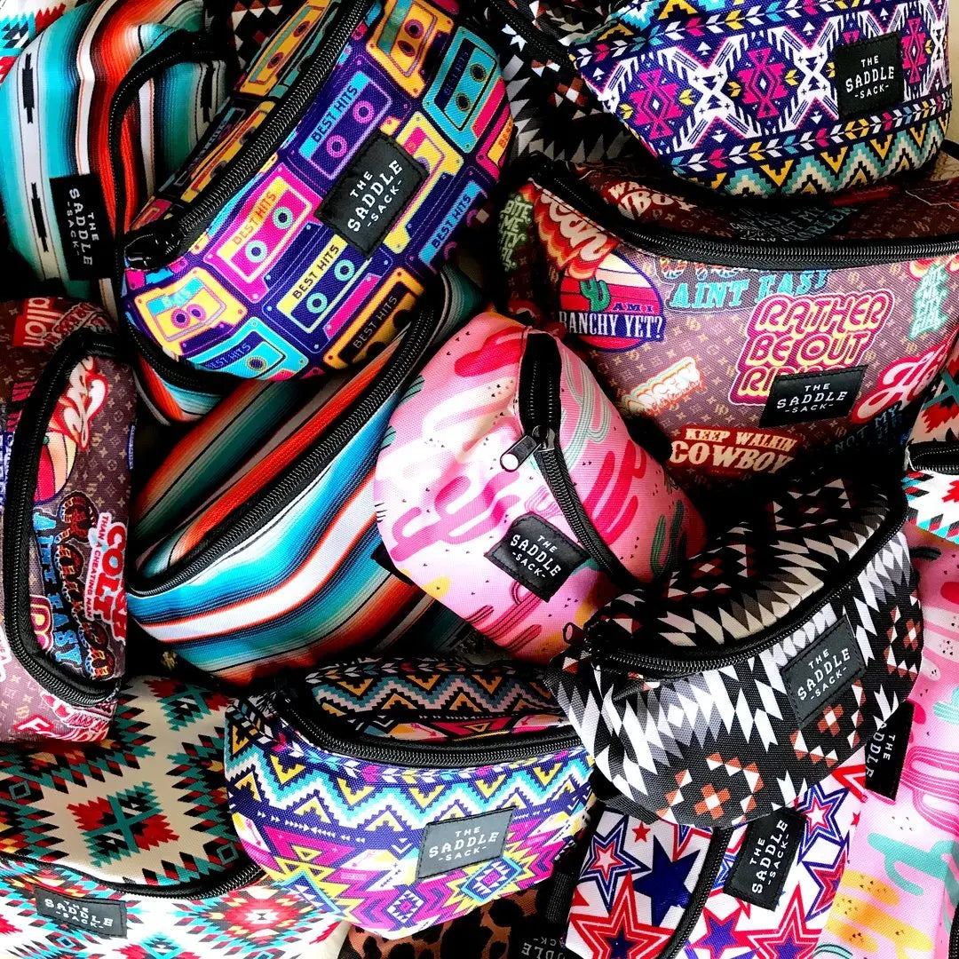 Colorful The Saddle Sack pet treat bags in assorted vibrant patterns and prints