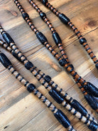 Black and tan braided rawhide Romal reins with woven texture