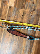 Brown leather horse halter with floral tooling and turquoise rope accents