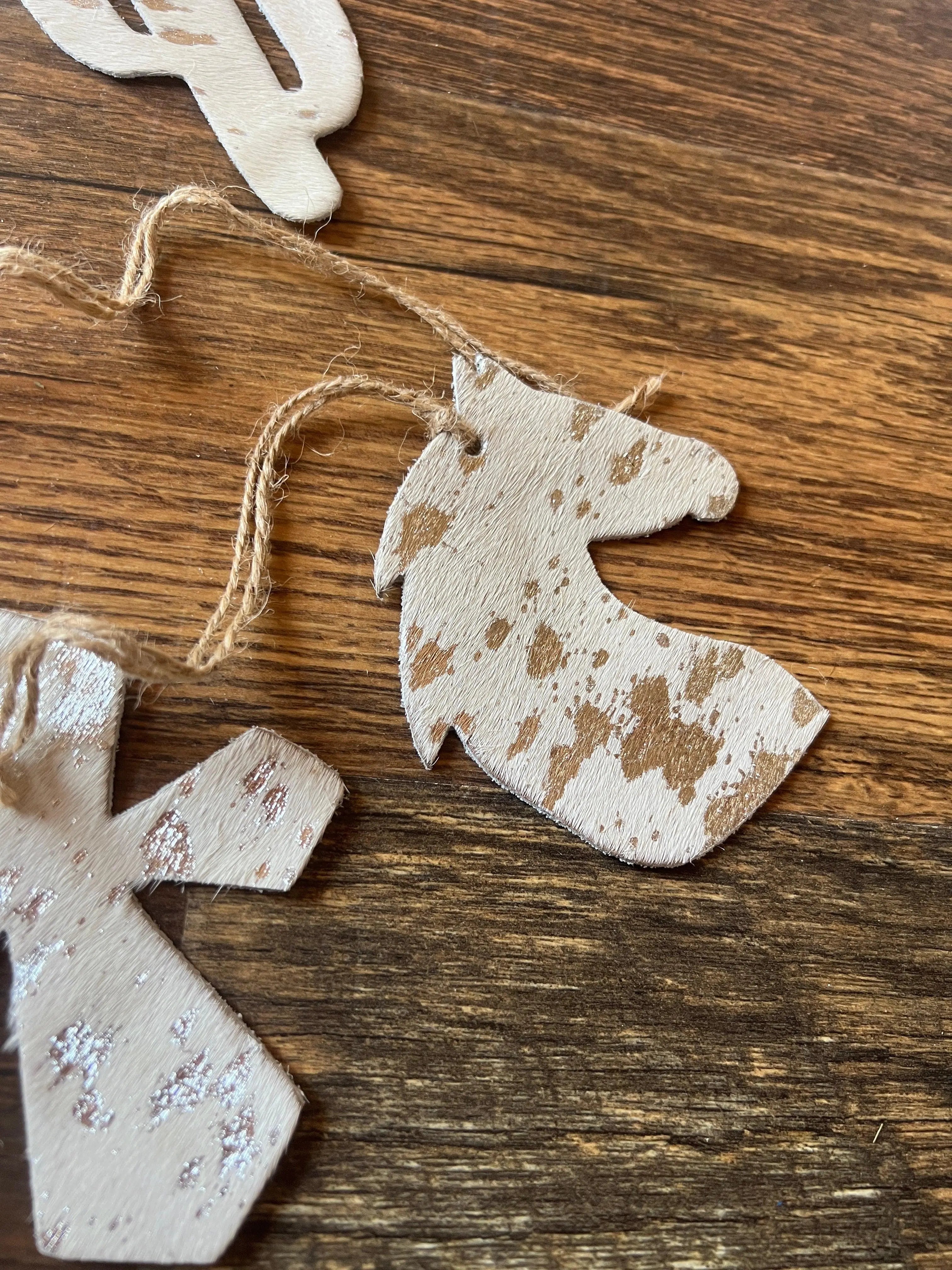 White horse-shaped cowhide ornament with brown acid wash speckles