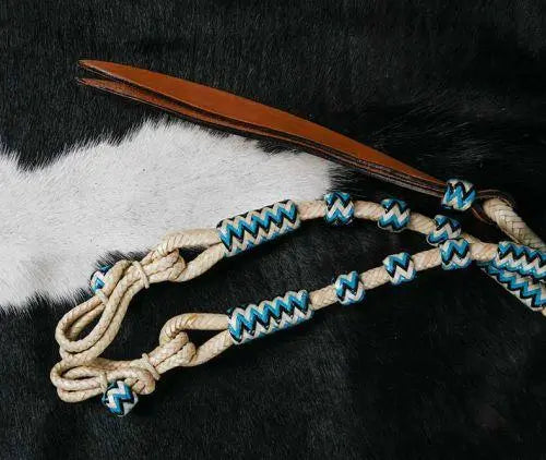 Beige and blue braided rope halter with tan leather ends on romal reins