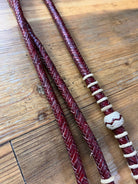 Deep red 20-plait romal reins with white accents, cherry rawhide bead, 55