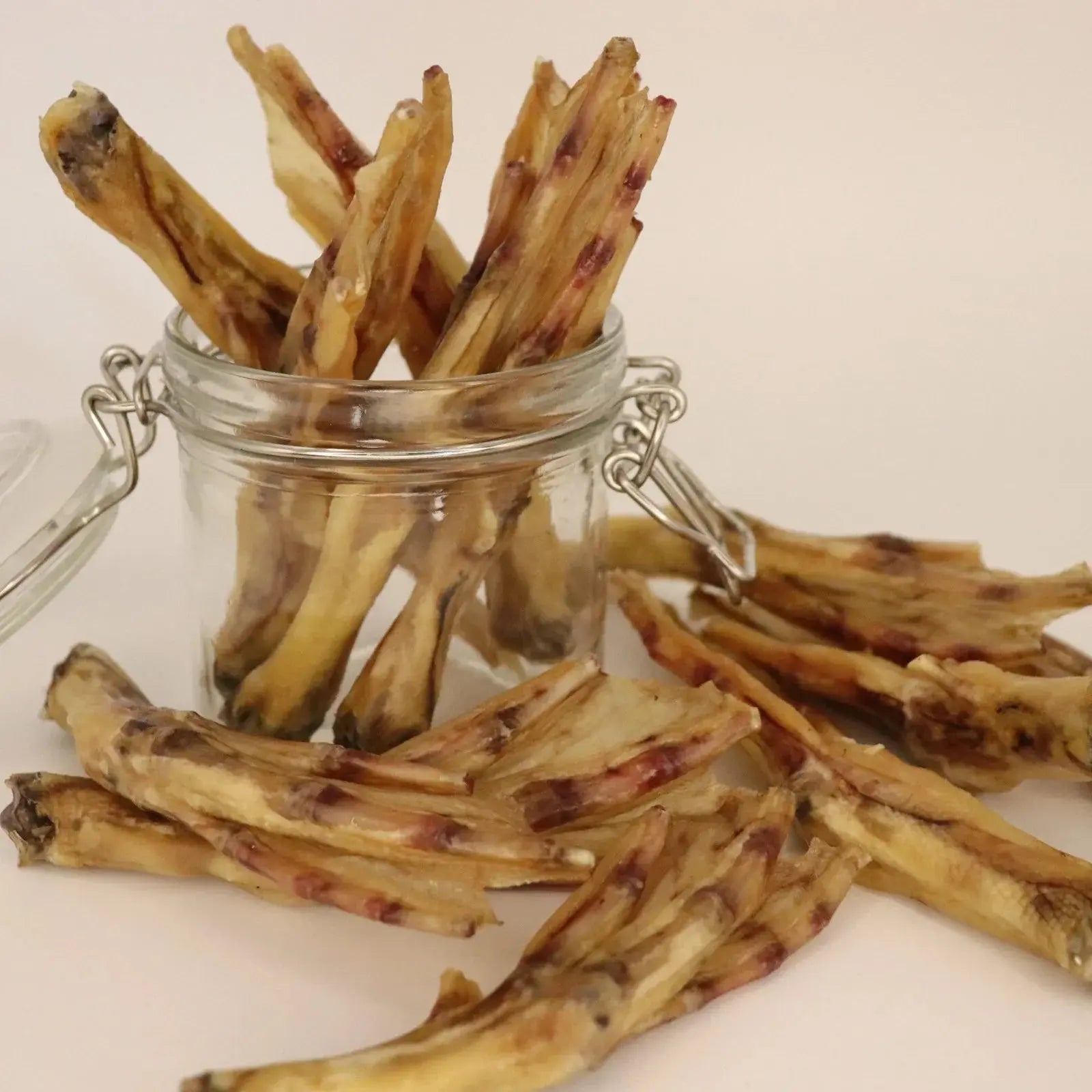 Duck feet dog treats in a glass jar, natural dehydrated chews for dogs