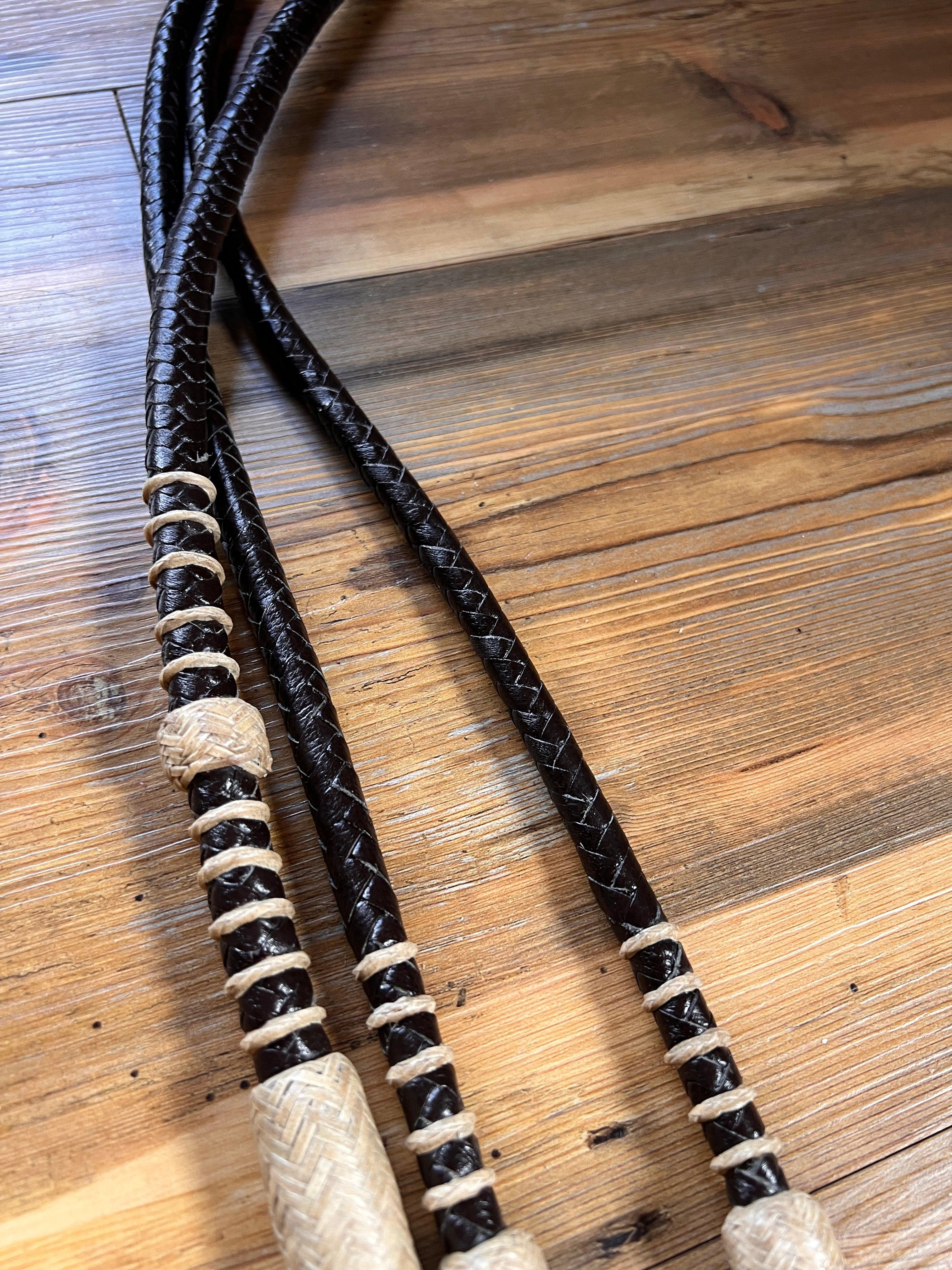 Black braided leather romal reins with cream woven handles, 10 plaits, 55-inch