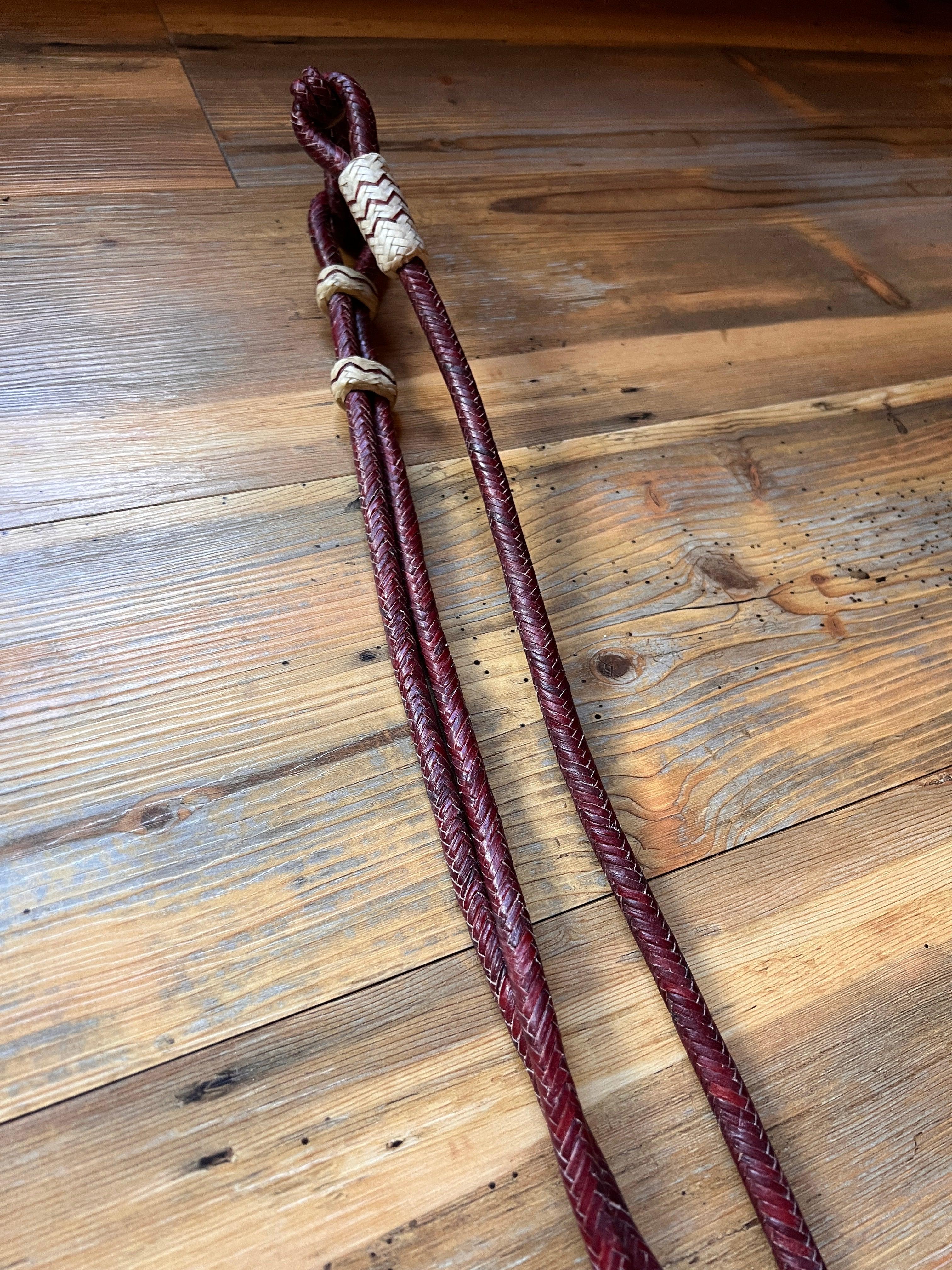 Dark reddish-brown 20-plait romal reins with white accents and knot