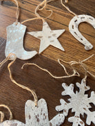 White cowhide cowboy boot, star, horseshoe, snowflake ornaments in silver brown acid wash