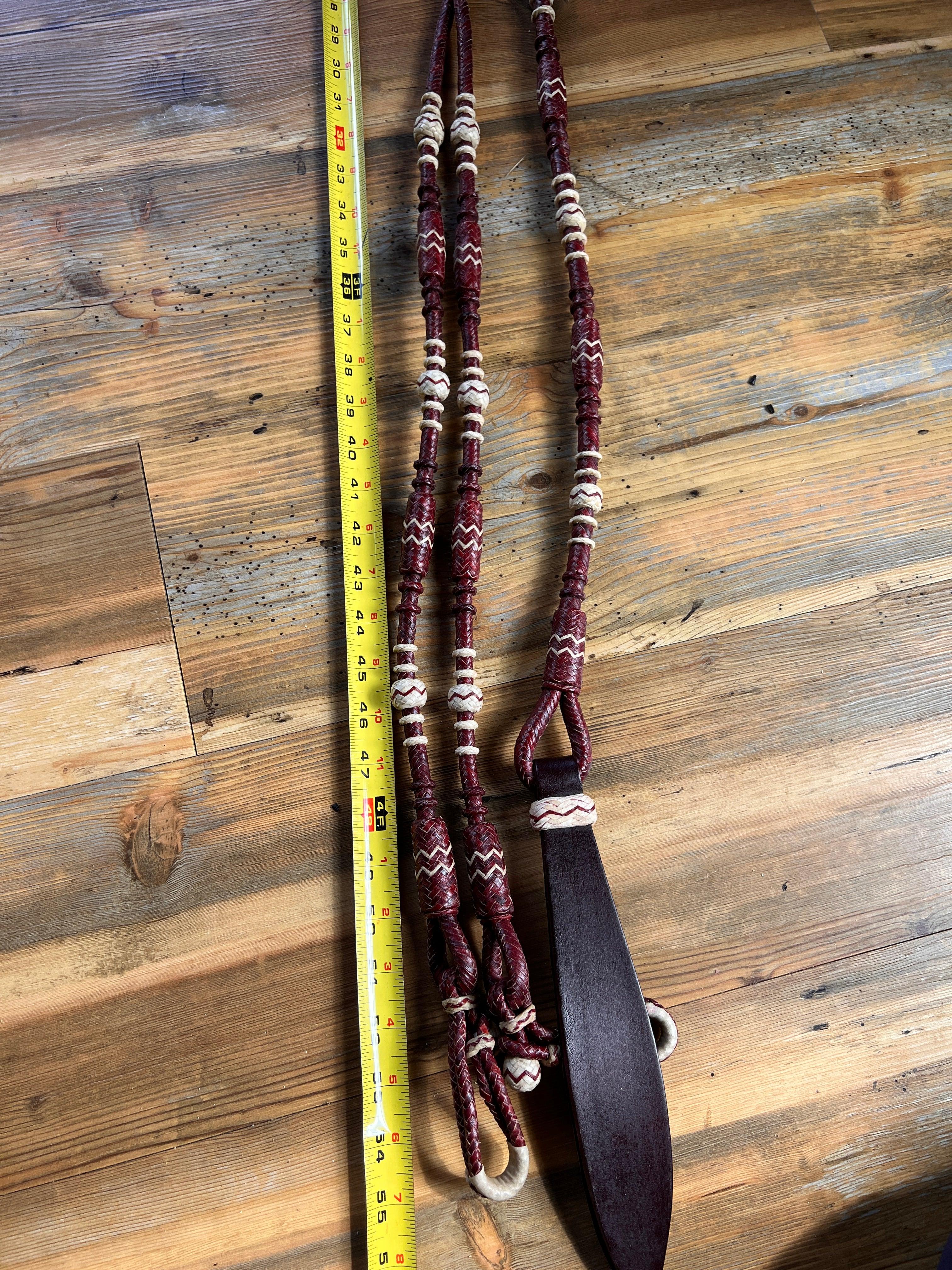 Maroon and cream 20-plait braided romal reins with dark brown leather bit