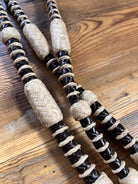 Black and beige woven rope-handled 10-plait romal reins, 55 inches