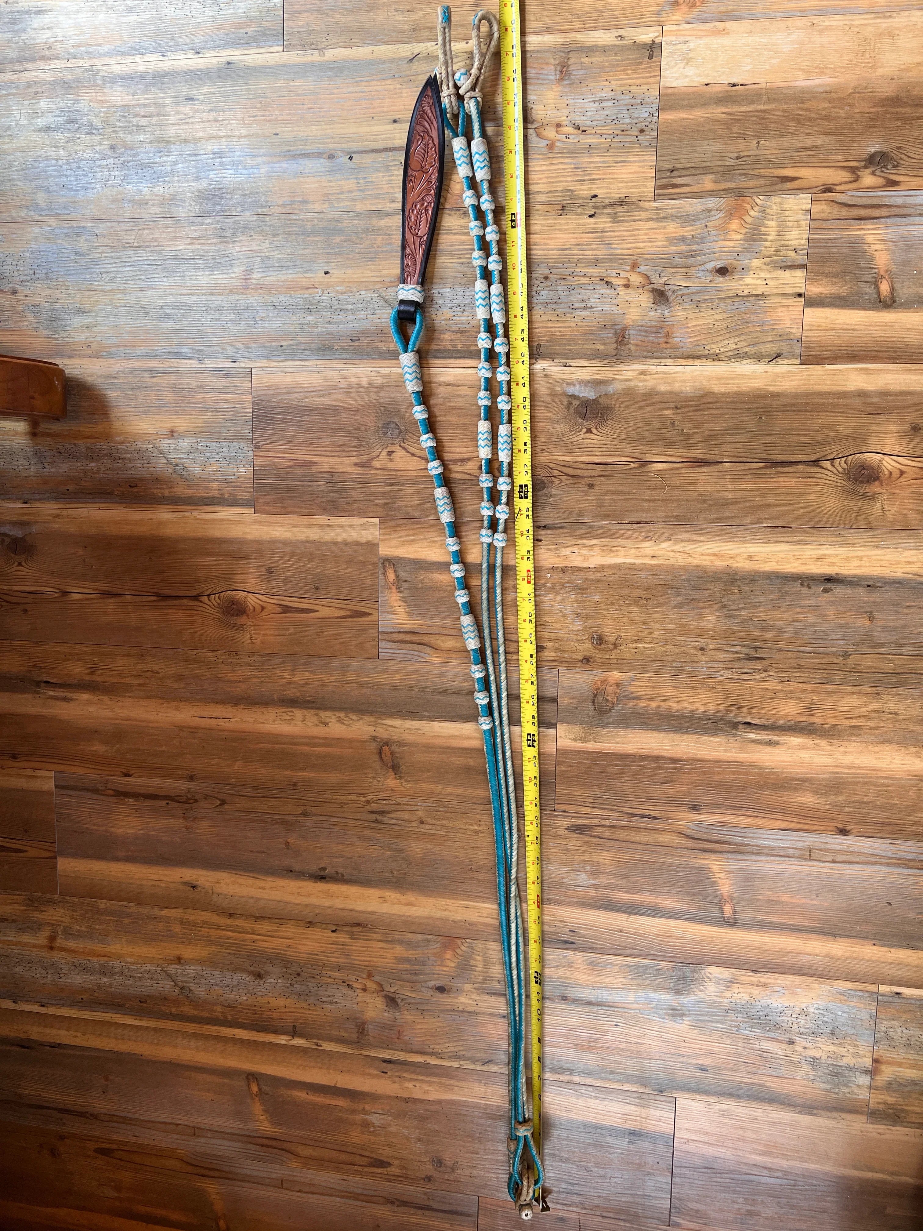 Teal and white 20-plait rawhide Romal reins with brown leather handle