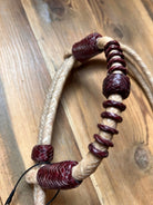 Hand-crafted braided leather one-ear Western horse headstall with tan and burgundy knots