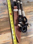 Brown leather knife sheath with woven texture on 10-plait romal reins